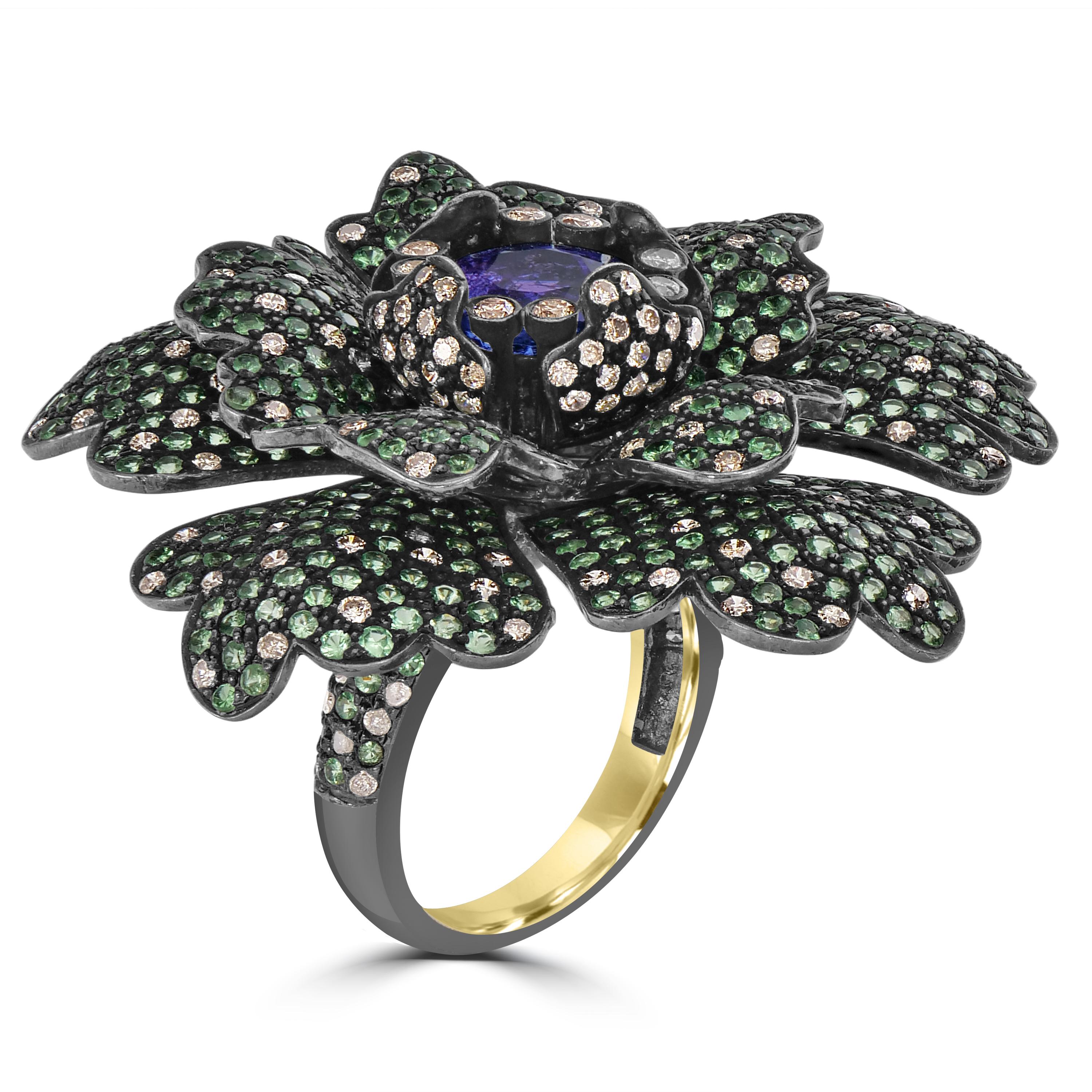 Elevate your jewelry collection with our stunning Victorian Floral Ring, a true embodiment of luxury and timeless beauty. This exquisite piece showcases the harmonious combination of a magnificent tanzanite, vibrant tsavorite, and dazzling diamonds,