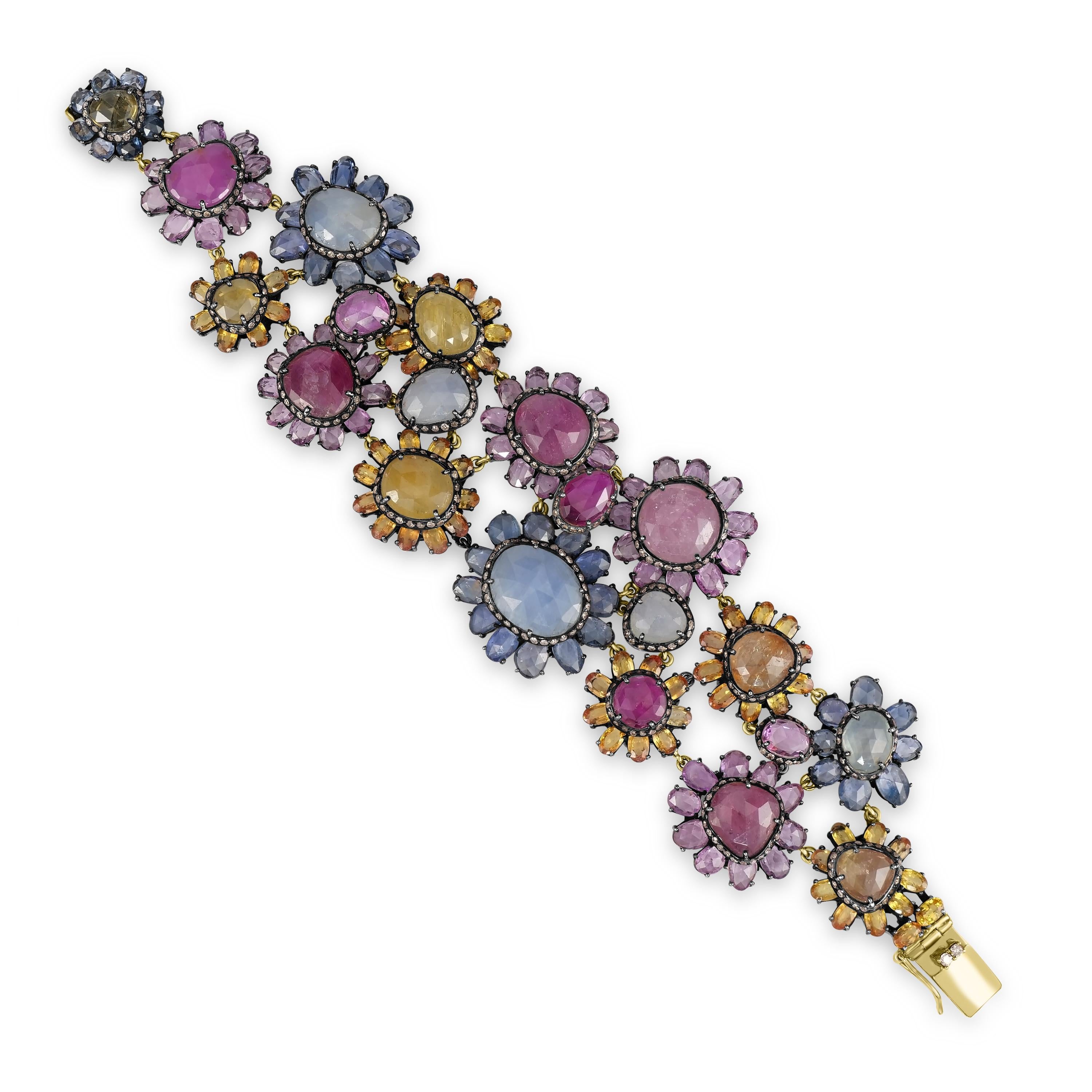 Introducing our breathtaking Victorian 110 Cttw. Sapphire, Ruby, and Diamond Link Bracelet, a true masterpiece of elegance and sophistication.

This stunning bracelet features a captivating collection of floral motifs adorned with vibrant sapphires
