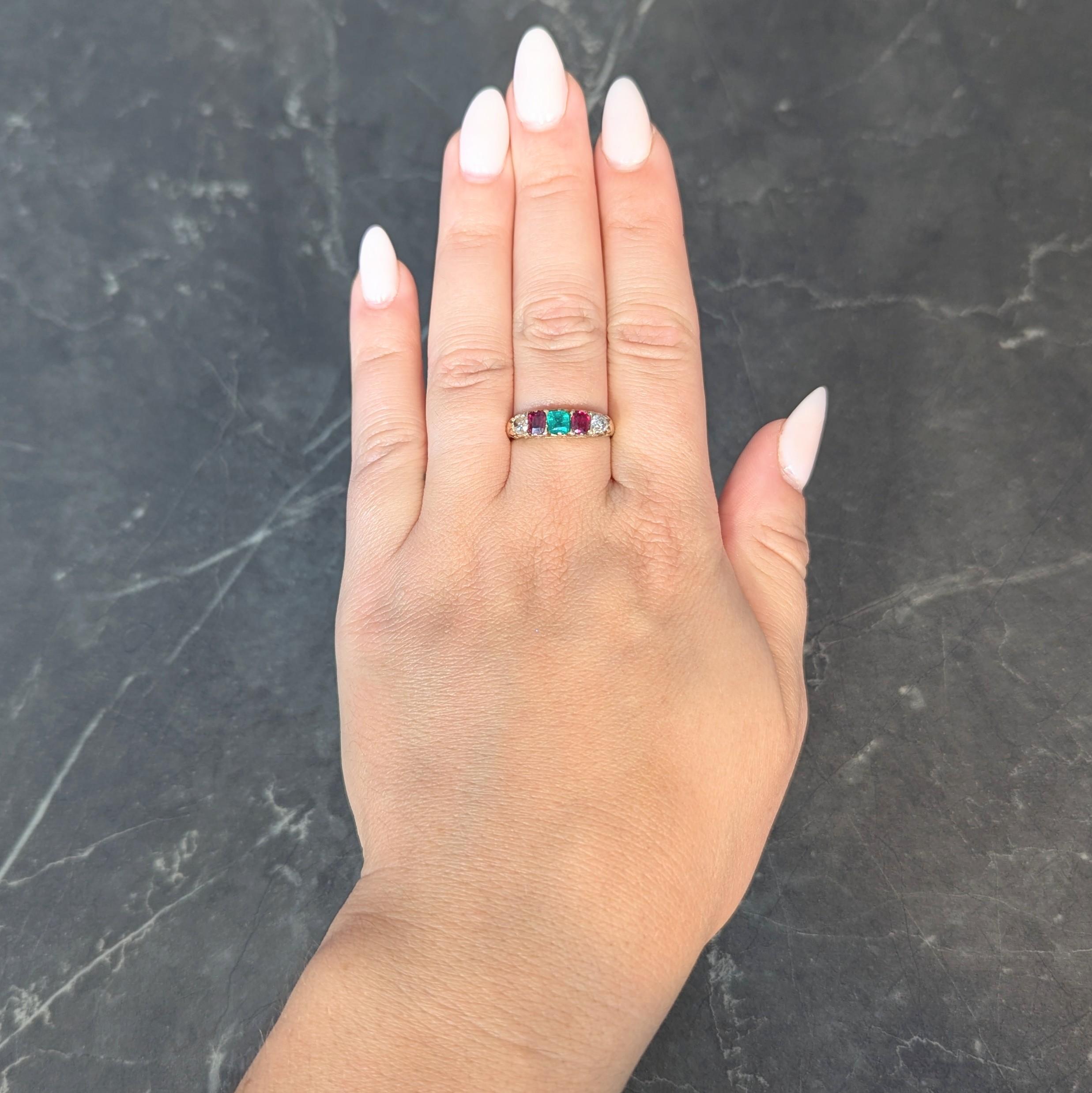 Centering a cushion cut emerald weighing approximately 0.28 carat - transparent medium green
Prong set and flanked east to west by cushion cut rubies and old mine cut diamonds
Rubies weigh approximately 0.52 carat total - transparent medium