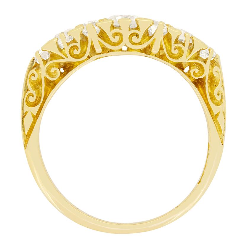 A beautiful piece of Victorian design, this carved shank ring showcases a sparkling collection of old cut diamonds. The central stone sits the largest at 0.40 carat, Either side are two 0.05 carat diamonds set vertically. Flanking these are two 0.20