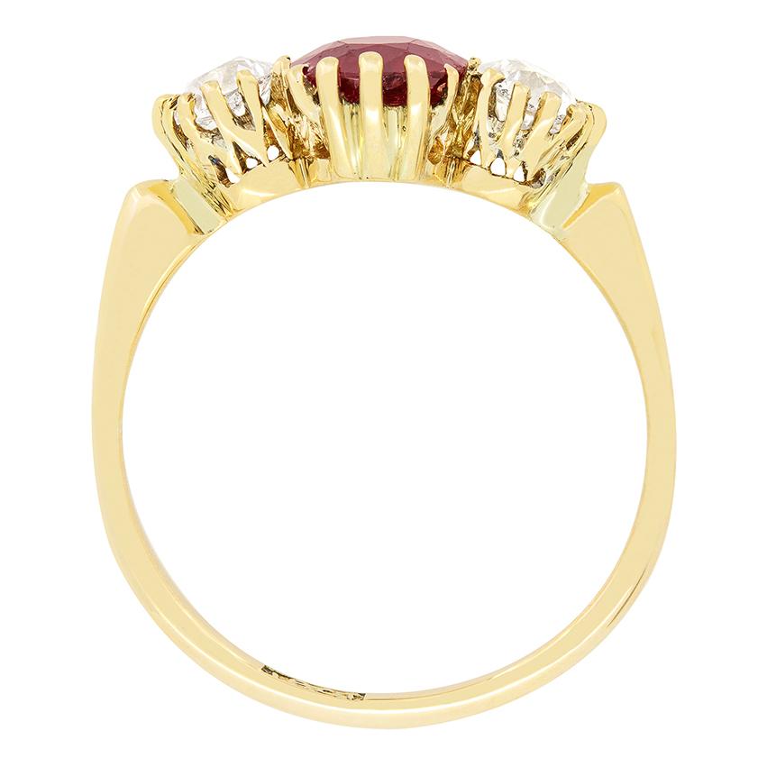 A natural unenhanced ruby is flanked by two glittering old cut diamonds in this beautiful Victorian trilogy ring. The1.10 carat ruby is a vivid red colour contrasting the diamonds perfectly. The old cut diamonds weigh 0.30 carat a piece and match in