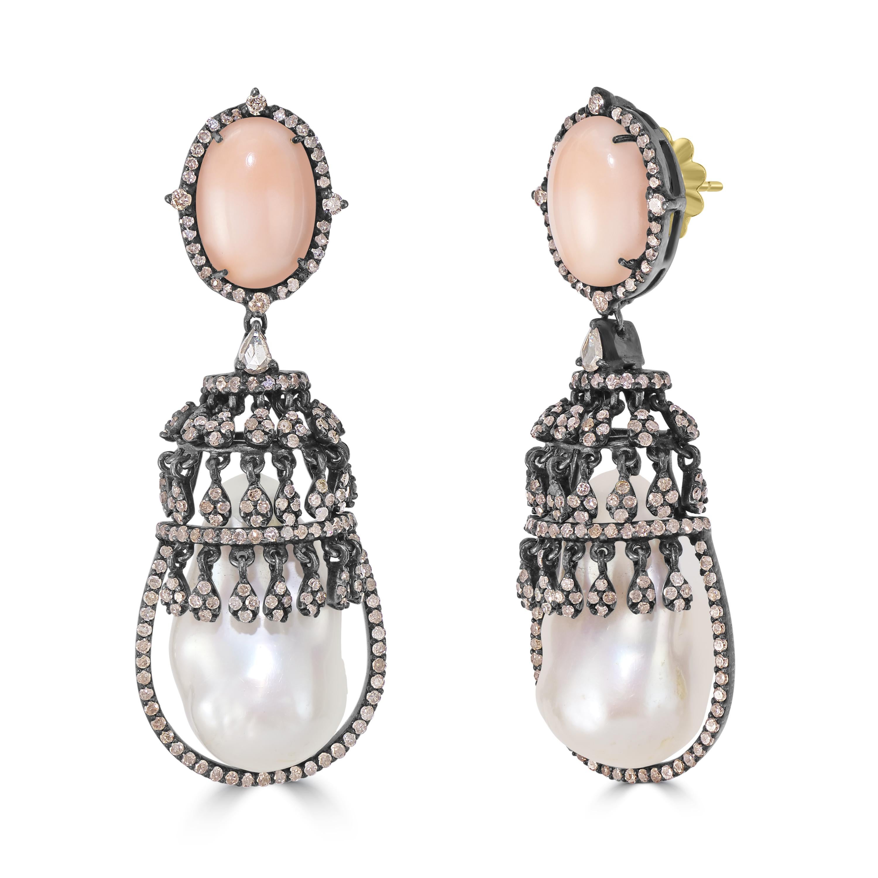 Introducing our Victorian 12 Cttw. Peach Coral, Diamond, and Pearl Drop Earrings – a masterpiece of sophistication and timeless allure.

At the summit of these earrings sits an oval peach coral embraced by a radiant diamond halo, set against a