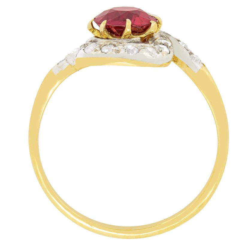 Dating back to the Victorian era is this charming ruby and diamond twist ring. The natural unenhanced ruby is a gorgeous deep red colour and weighs 1.20 carat. A halo of graduated old cut diamonds, set in platinum, surrounds the claw set ruby and