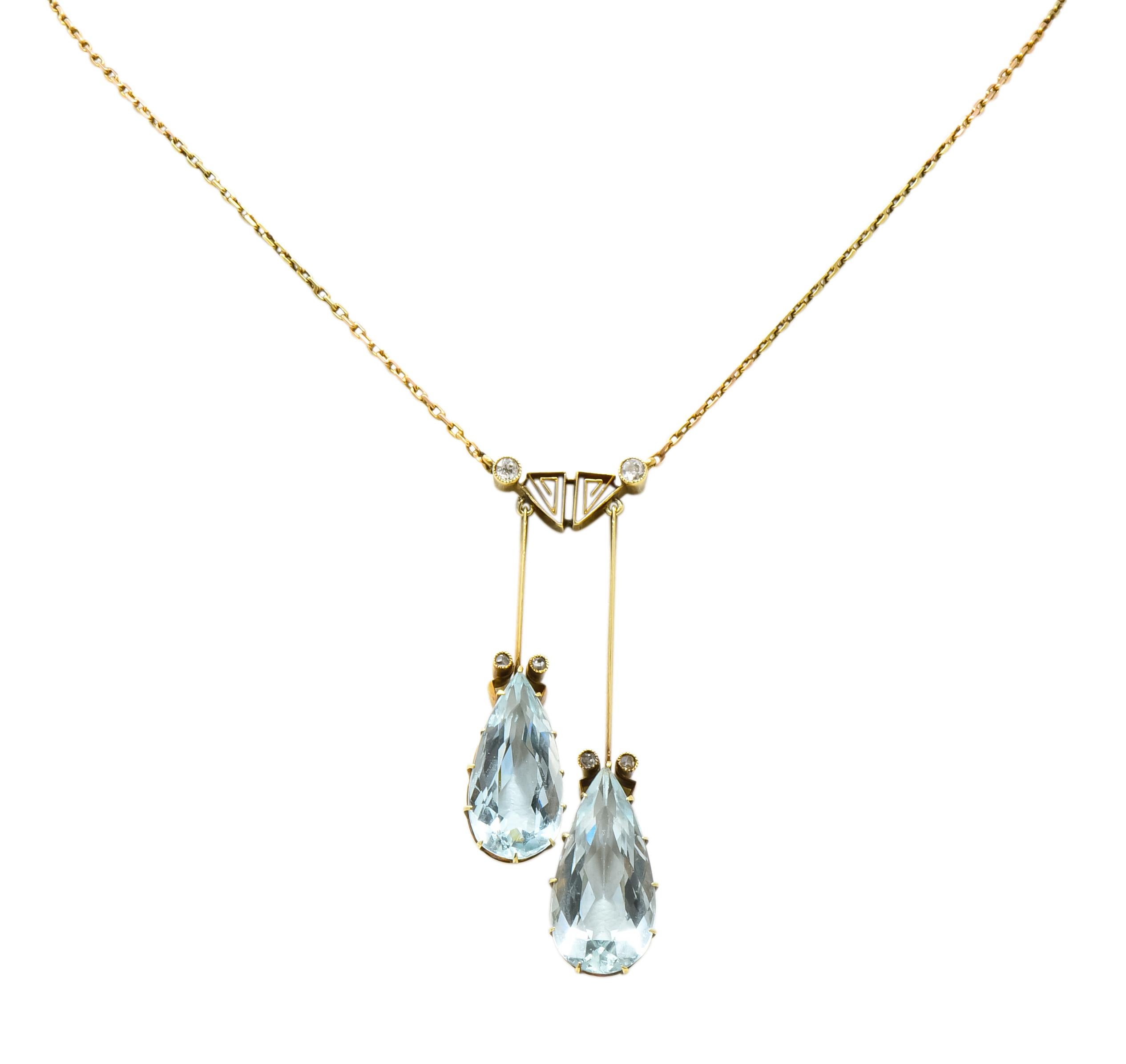 Centering two pear cut aquamarines weighing approximately 12.00 carats total, transparent and light blue in color

Claw set and suspended from two, articulated linear bars and stylized Greek key station

Accented by six bezel set rose cut and and