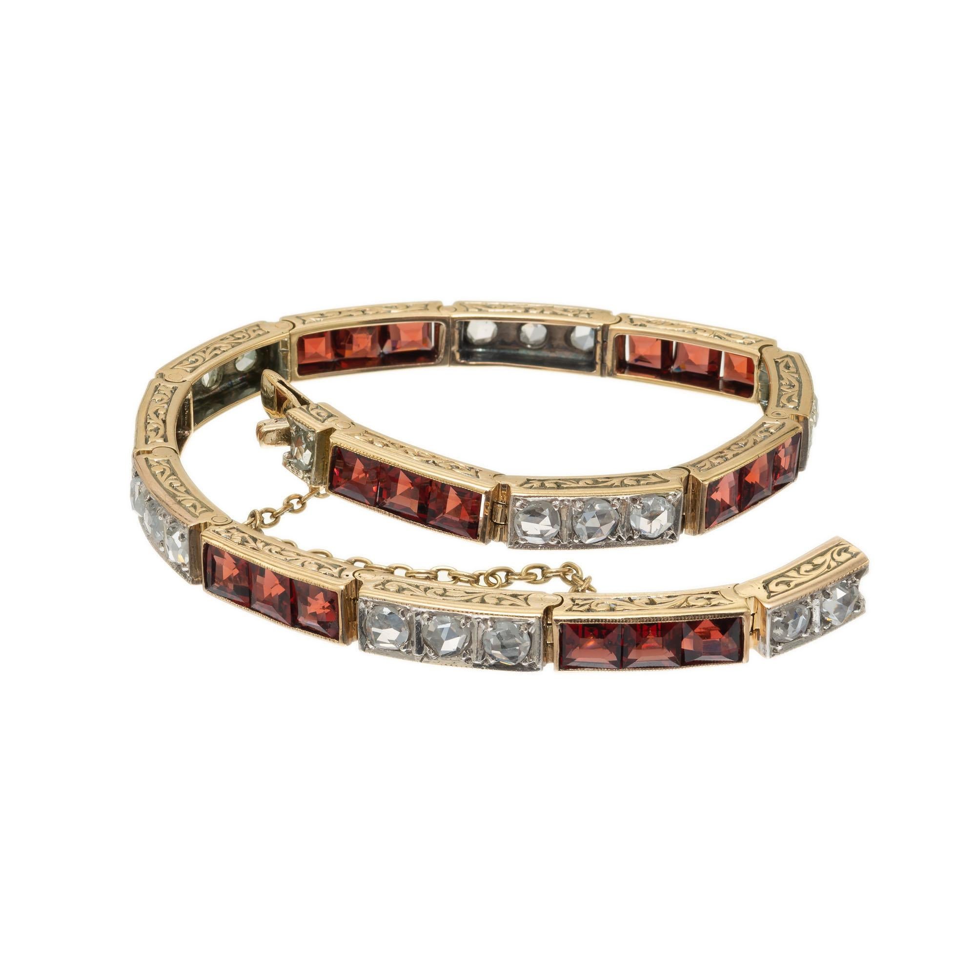 Garnet and diamond hinged link line bracelet with engraved sides. Set with 1.30 carats of rose cut diamonds and 3.75 carats of square cut garnets in 14k yellow gold.  Built in catch and safety chain. 6.5 inches in length. 

20 rose cut diamonds, H-I