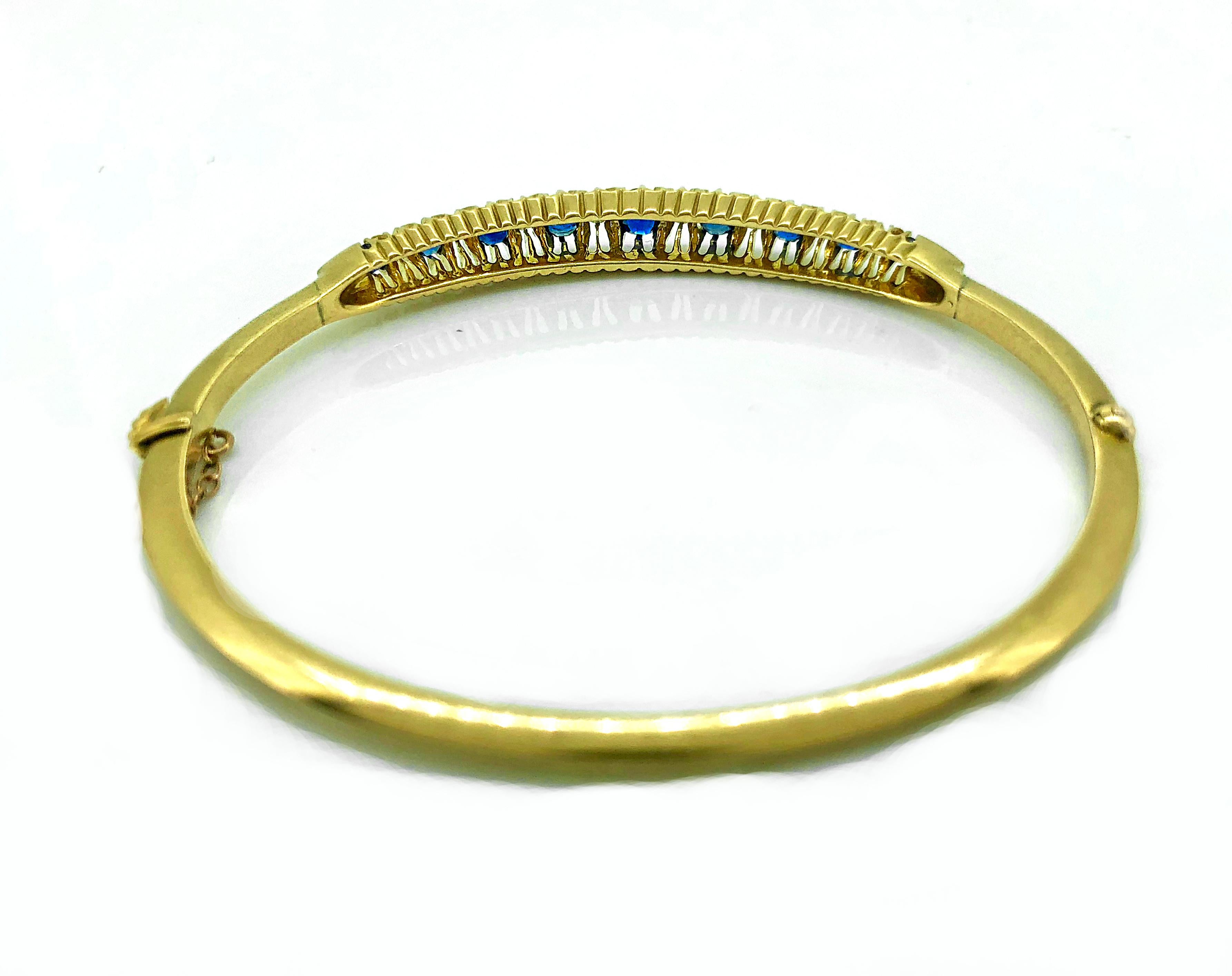 A completely original Victorian sapphire and diamond Antique bangle bracelet featuring 1.33ct. apx. T.W. of natural vivid blue-Antique cushion cut sapphires and .20ct. apx. T.W. of old mine cut diamonds that are I1-I2 clarity and D-E color. As are