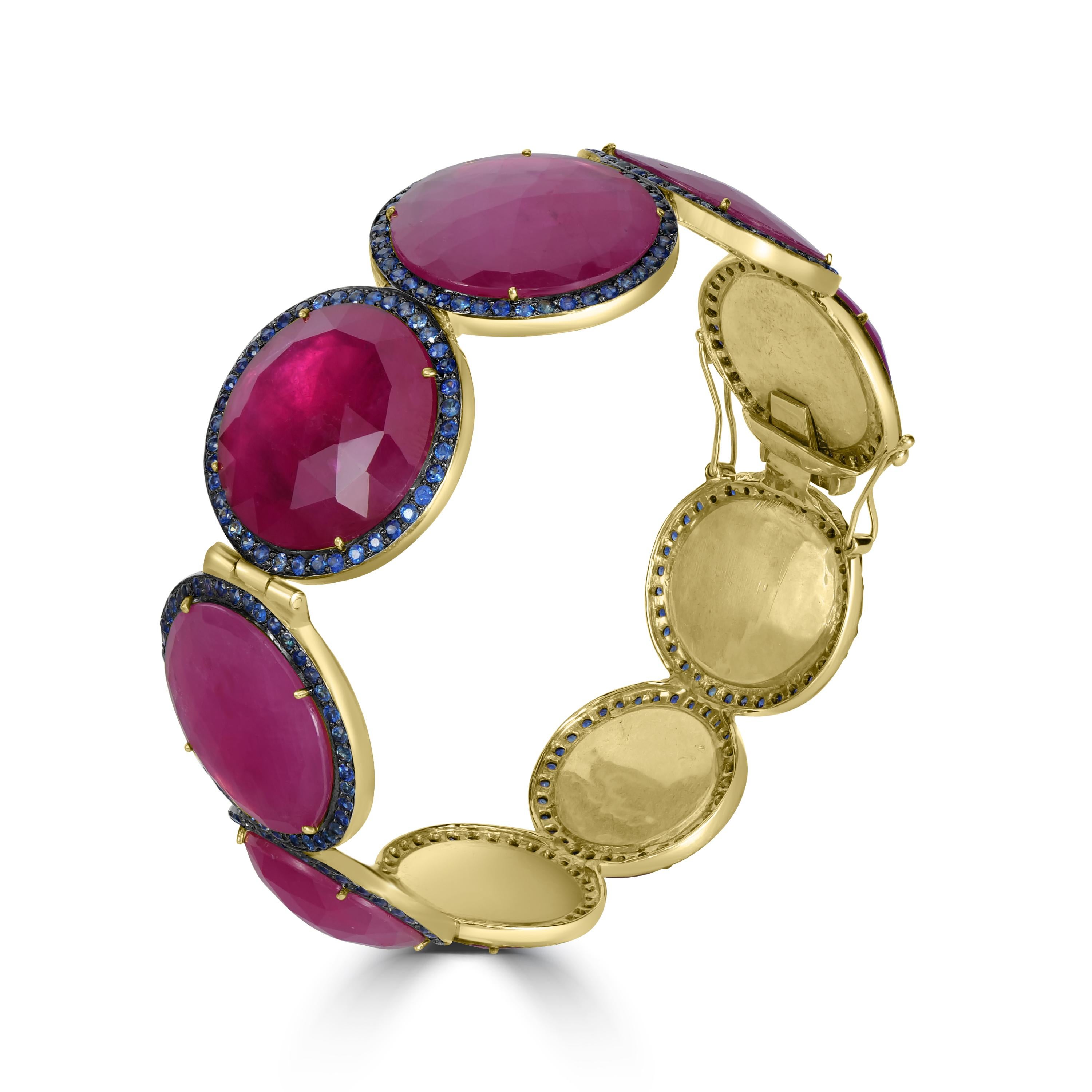 Step into a world of opulence and elegance with our Victorian Ruby and Blue Sapphire Station Bracelet, a captivating piece that exudes sophistication and luxury.

Crafted with meticulous attention to detail, this exquisite bangle features a series