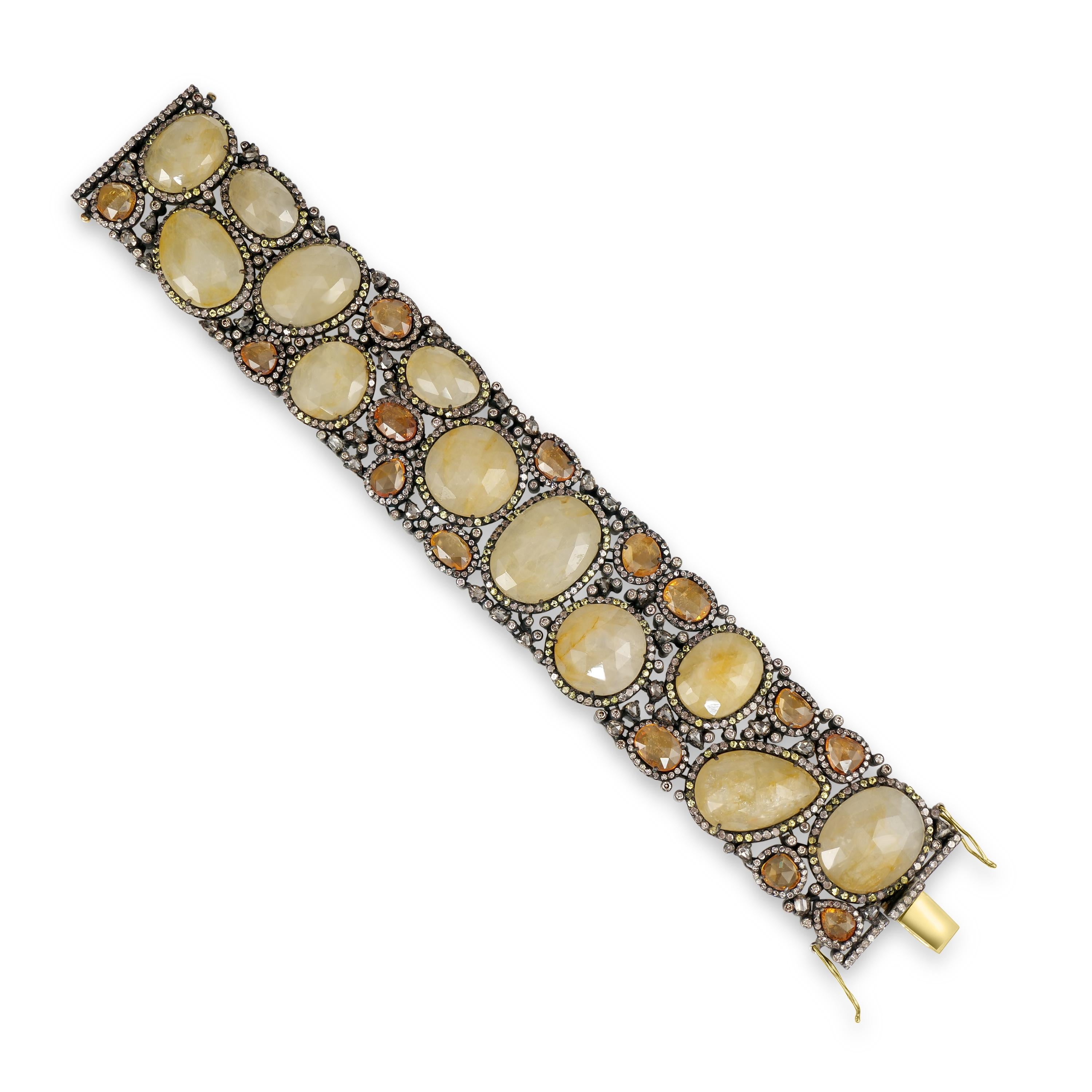 Behold the splendor of the Victorian era with this magnificent 135 Cttw. Sapphire and Diamond Open Work Bracelet. A luxurious tapestry of gemstones, this bracelet is a celebration of opulence and artistry. Large oval, round, and pear-shaped