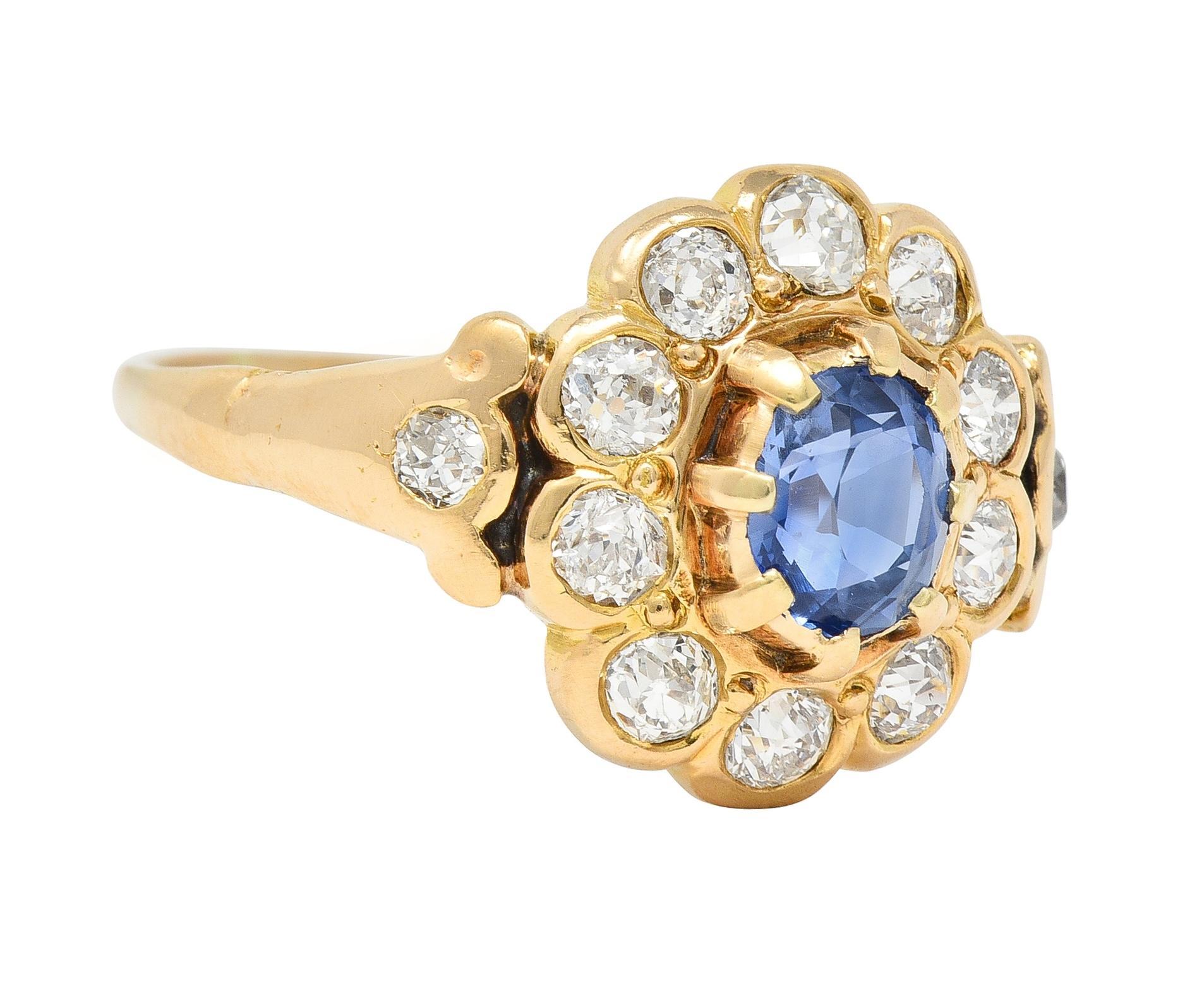 Centering an oval cut sapphire weighing approximately 0.71 carat total - transparent medium blue in color
Set in a gold bezel with extruding prongs and featuring old European cut diamonds in halo surround
Bezel set with additional diamonds flush set