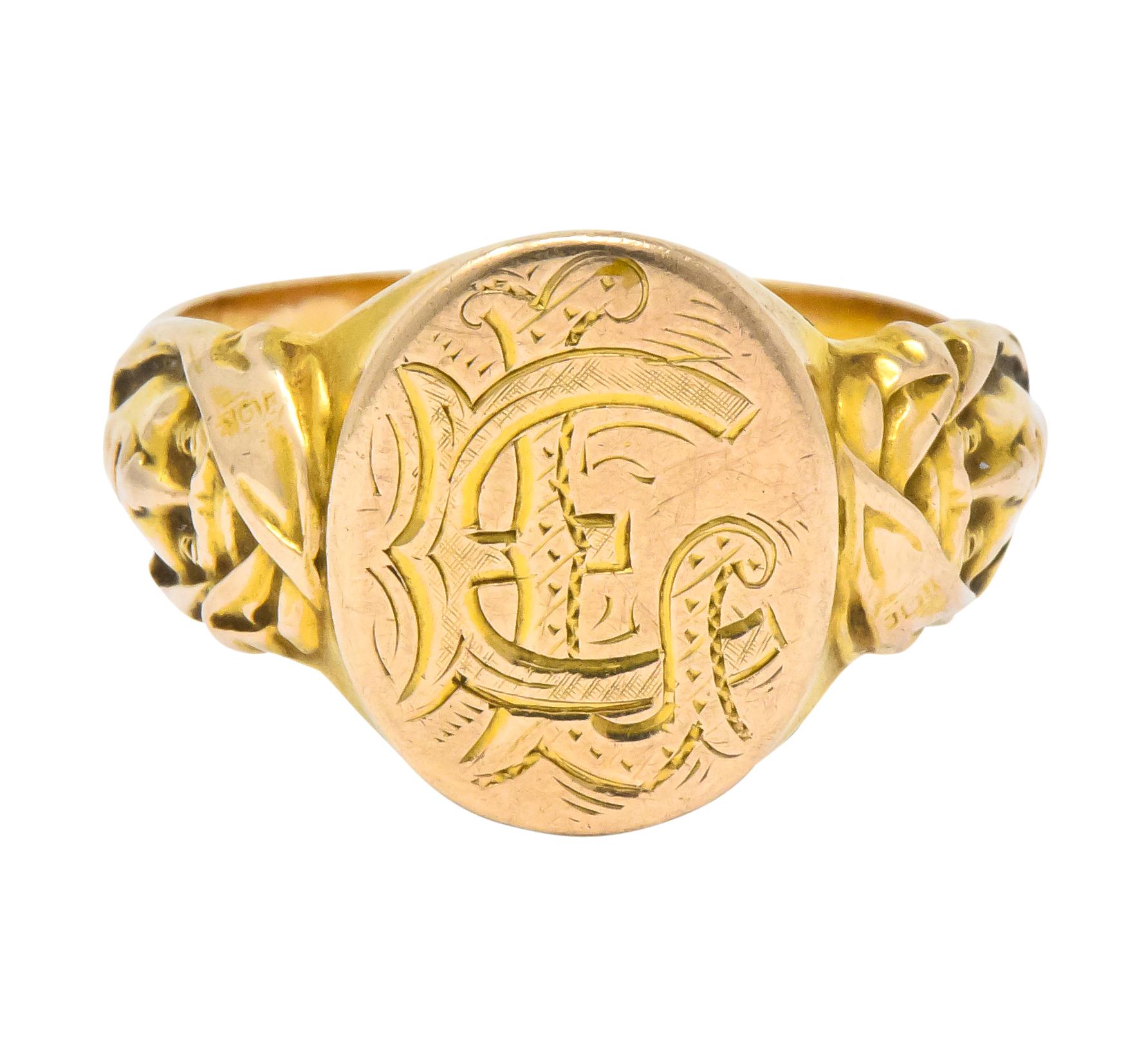 Signet ring deeply engraved with decorative intersecting initials 'EL'

Flanked by high relief cloaked faces as ring's shoulders

With maker's mark and tested as 14 karat gold

Ring Size: 9 & sizable

Top measures: 14.1 mm and sits 1.6 mm