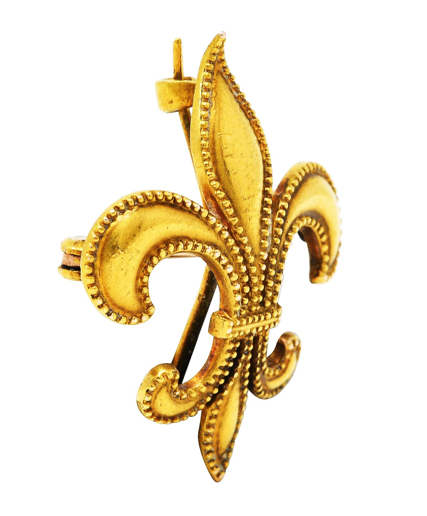 Pendant brooch designed as stylized whiplash fleur-de-lis symbol

Featuring milgrain edges

Completed by hinged pin stem and looping bale - perfect for optional drop, watch or locket

Stamped 14k for 14 karat gold

With maker's mark

Circa: