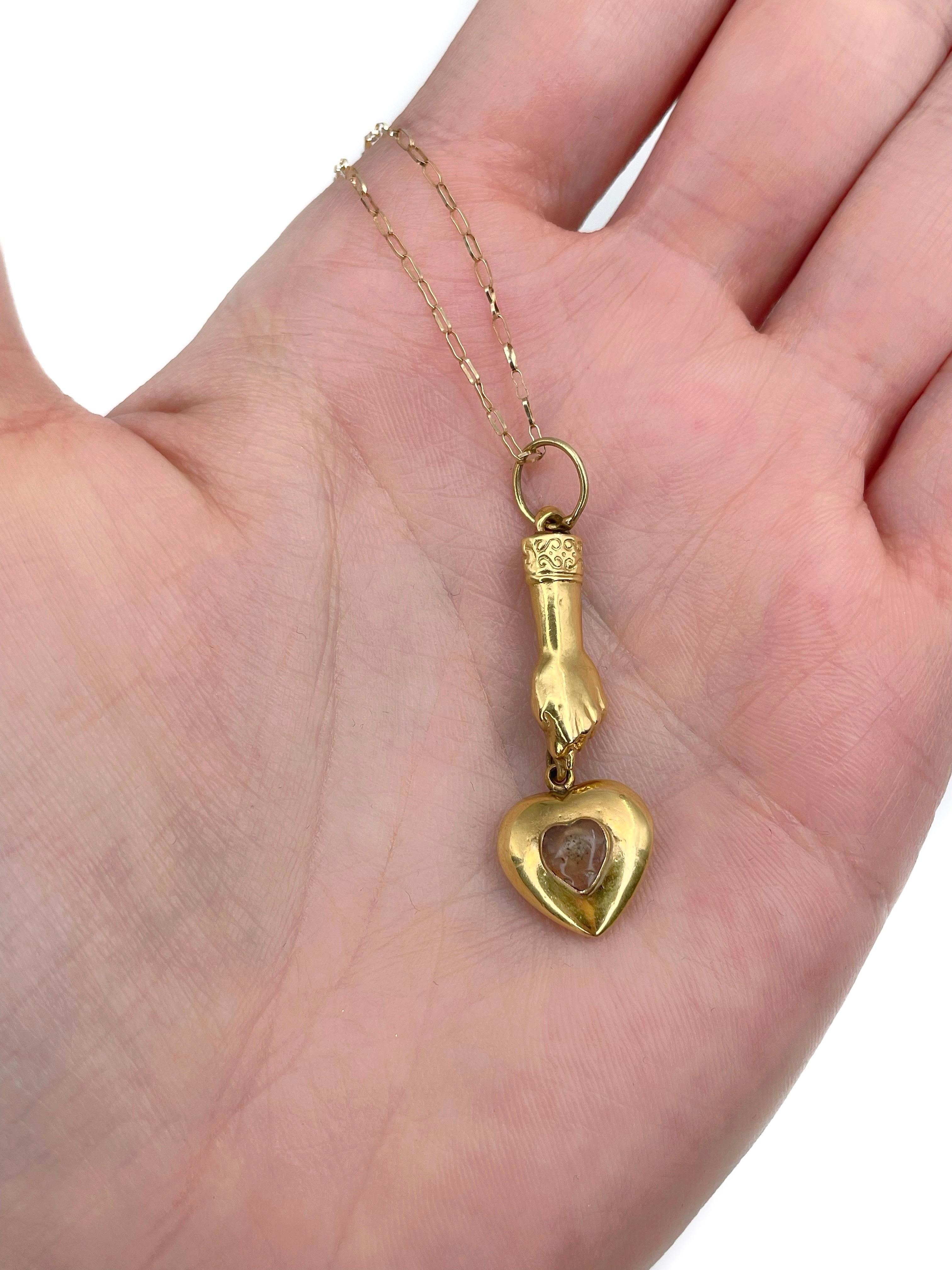 This is a Victorian pendant with a chain crafted in 14K yellow gold. Circa 1890. 

The piece features good luck charm “Mano Figa” and a  heart encrusted with agate. 

Weight: 2.51g
Pendant length: 4cm
Chain length: 45.5cm

———

If you have any