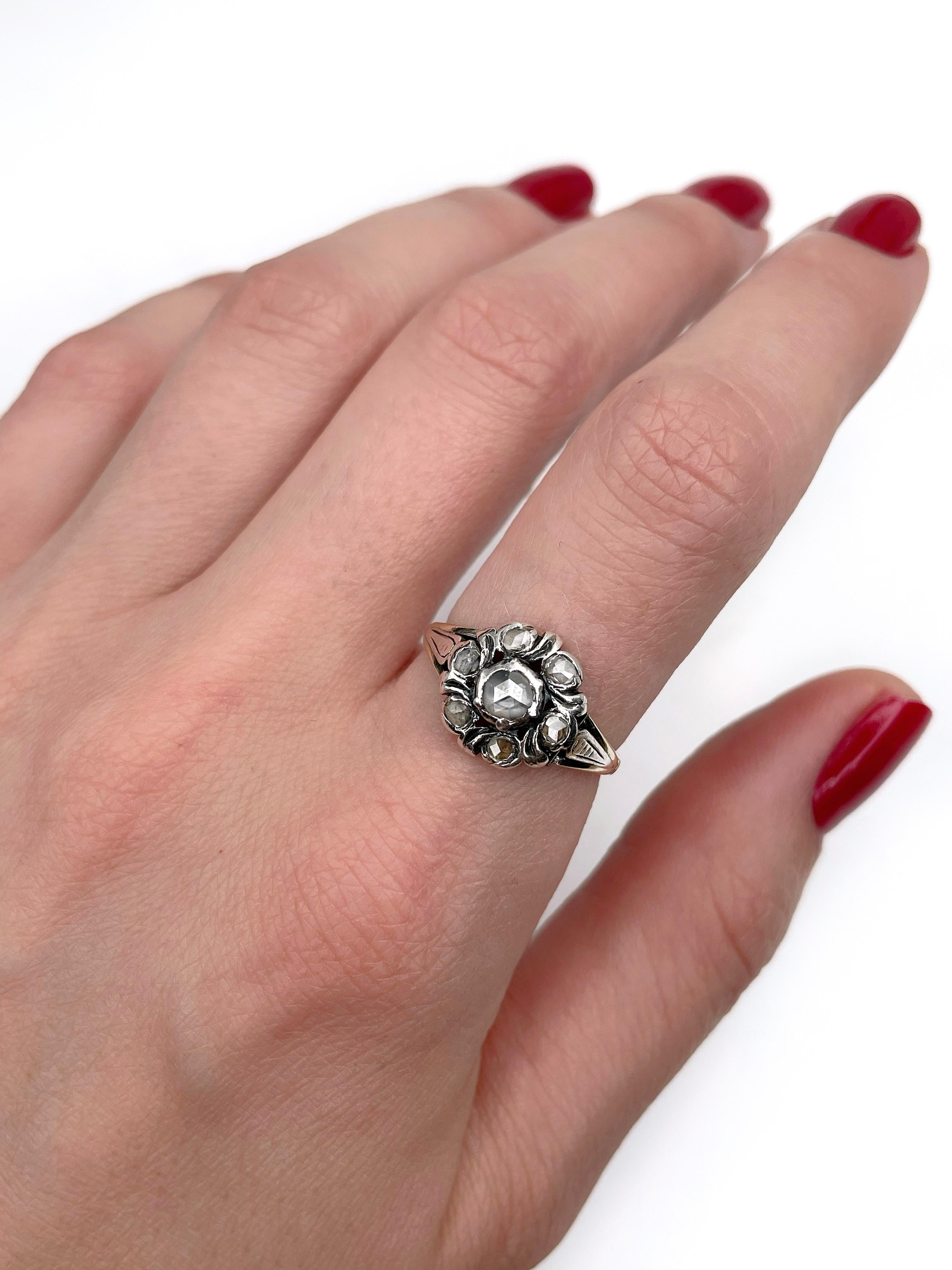 This is a Victorian cluster ring crafted in 14K gold and adorned with silver. It features 7 rose cut diamonds: TW 0.25ct, STW, P1-P2. 

Weight: 3.21g 
Size: 17.5 (US 7.25)

IMPORTANT: please ask about the possibility to resize before purchase. This