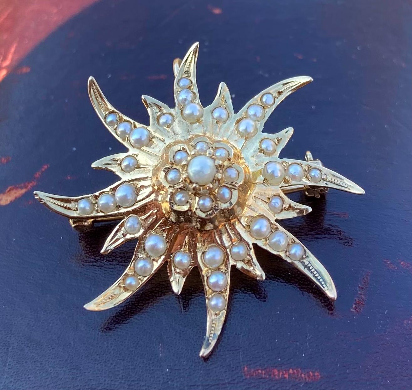 One 14 karat yellow gold (acid tested) Victorian seed pearl starburst design pendant/brooch set with forty-five (45) seed pearls.  The pendant measures 1.25