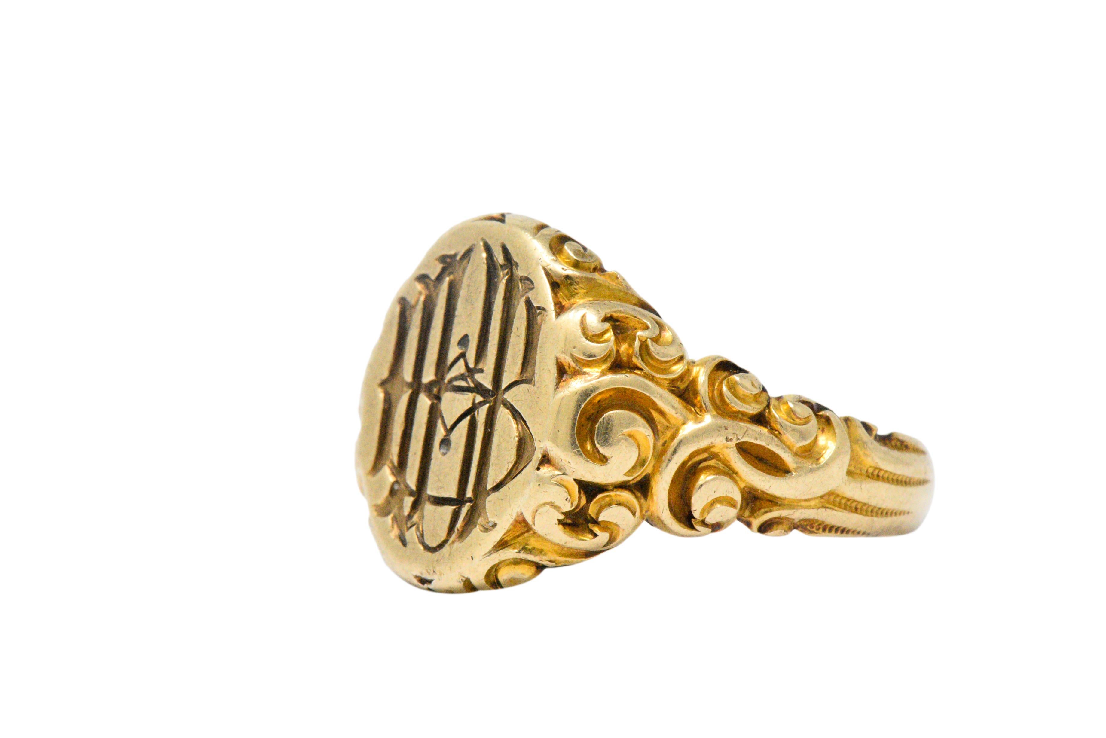 With a deep intricate carved monogram of interlocking letters

With stunning highly detailed scrolling gold work on each side and going part-way down the shank

The history of signet rings dates back to 3500 BCE, and have been worn by Pharaohs,