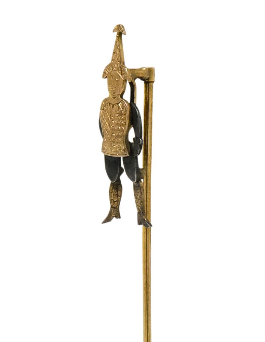 Designed as a jester with movable arms and legs

Engraved gold motley, stockings and hat 

Engraved silver legs and arms

Tested as 14 karat rose gold

Jester Length: 1 1/8 Inches

Total Length: 3 3/4 Inches

Total Weight: 3.1 Grams

Fool. Jokester.