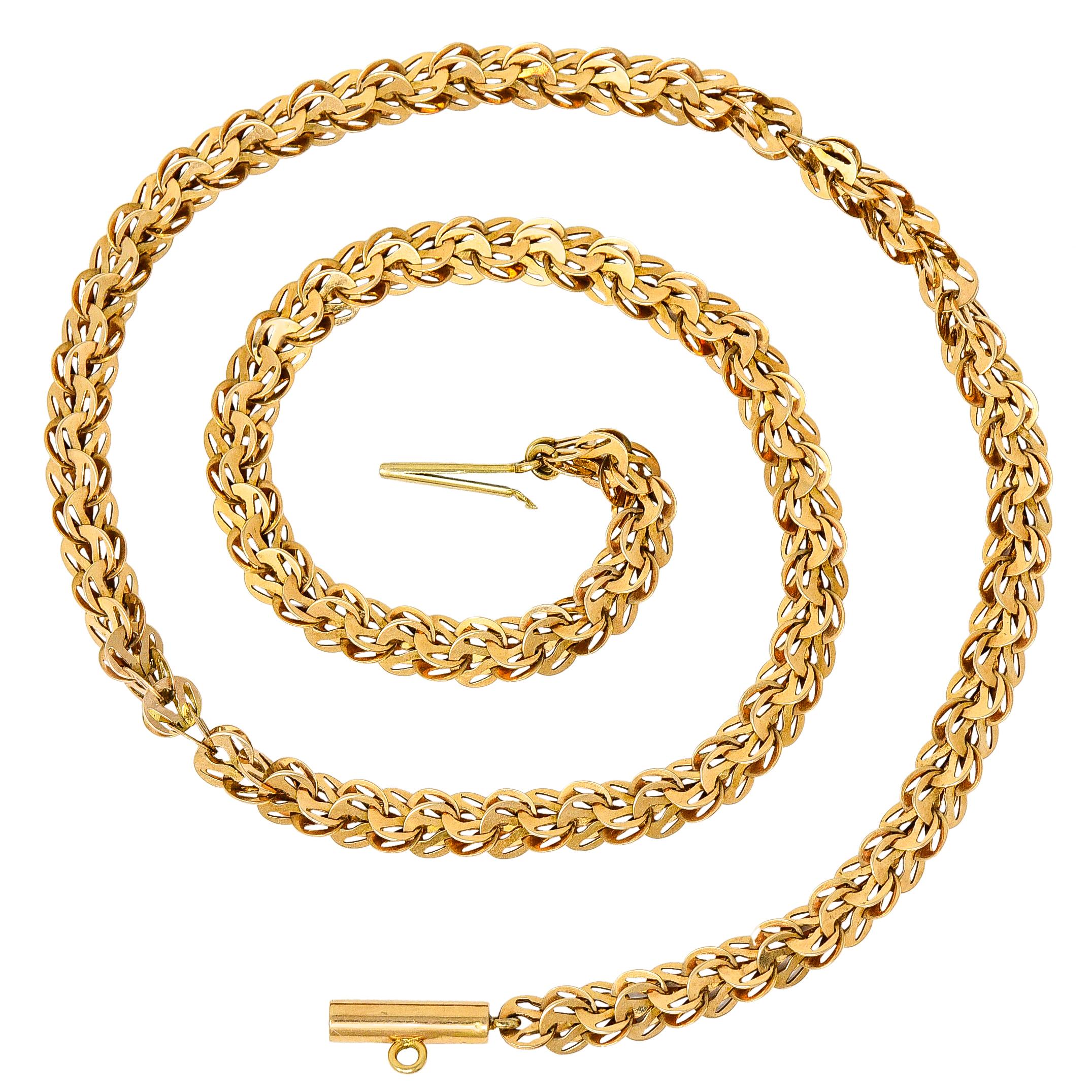 Chain necklace is comprised of pairs of intersecting discoid links

Fancily pierced with a brightly polished finish

Completed by a barrel clasp

Tested as 14 karat gold

Circa: 1900

Length: 19 1/2 inches

Width: 1/4 inch

Total weight: 19.5