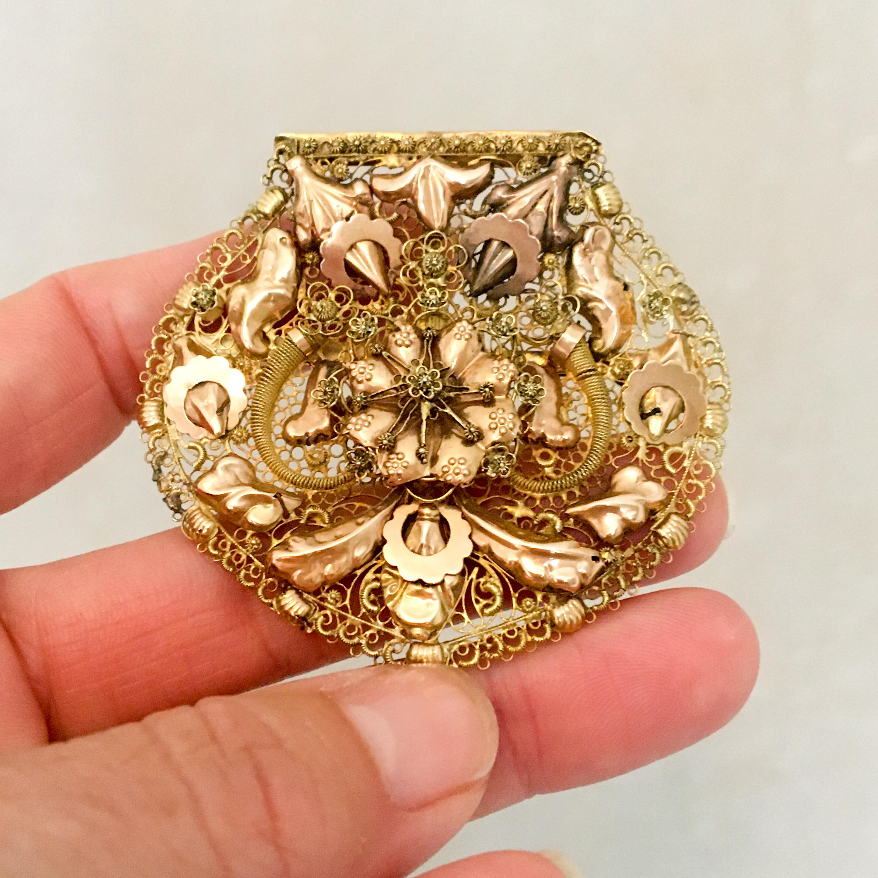 An antique 19th century 14 karat gold brooch created with filigree and cannetille work. This brooch typically features fine gold wires or thinly hammered sheets. Jewelry with cannetille was very popular in the 1900's, particularly in the 1820's and