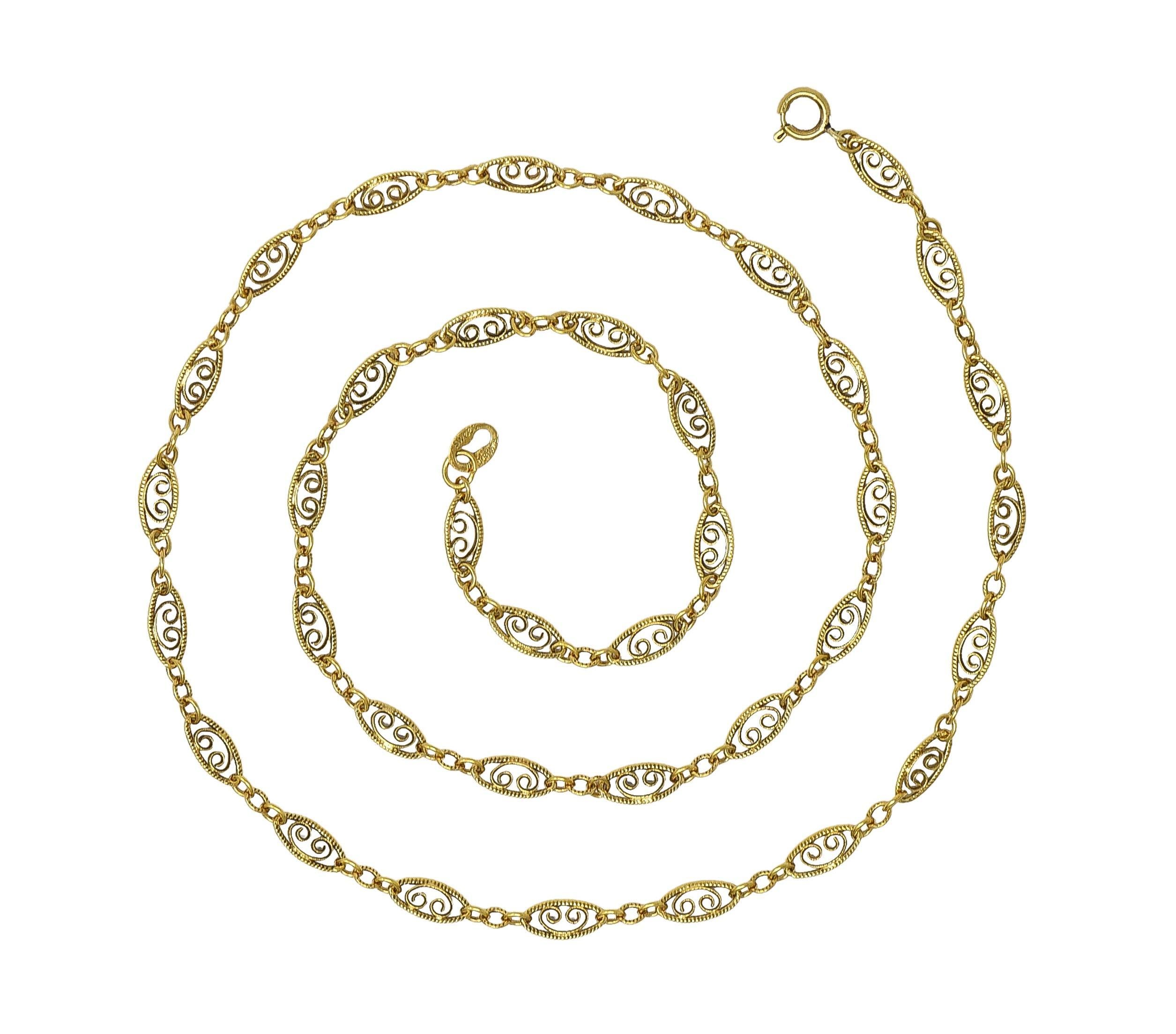 Comprised of navette-shaped links alternating with cable link chain segments 
Navette-shaped links center scrolling 'C' motif 
With milgrain detail throughout 
Completed by spring clasp closure
Stamped for 14 karat gold 
With maker's mark
Circa: