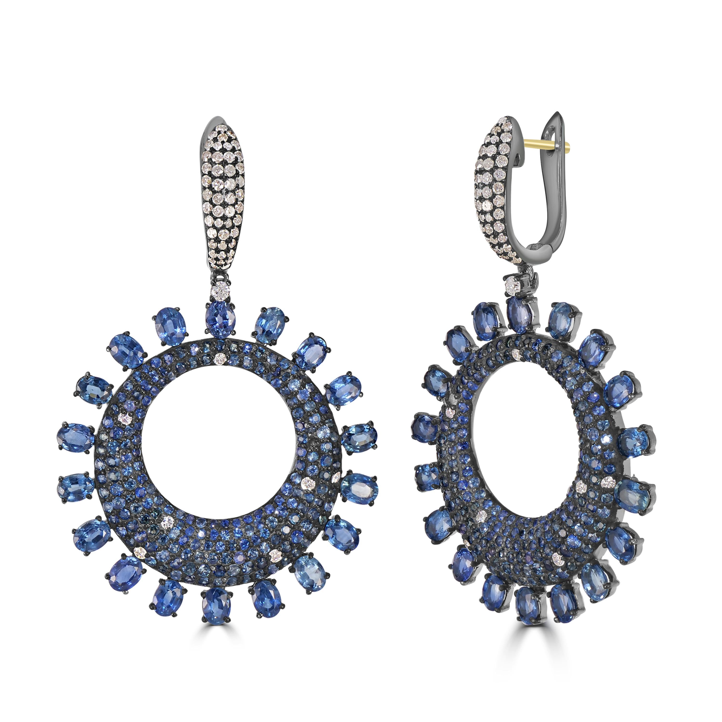 Behold the resplendent Victorian 14.09 Cttw. Blue Sapphire and Diamond Dangle Earrings—a testament to the exquisite beauty of blue sapphires and the timeless allure of circular design.

At the heart of these earrings is a circular drop, a
