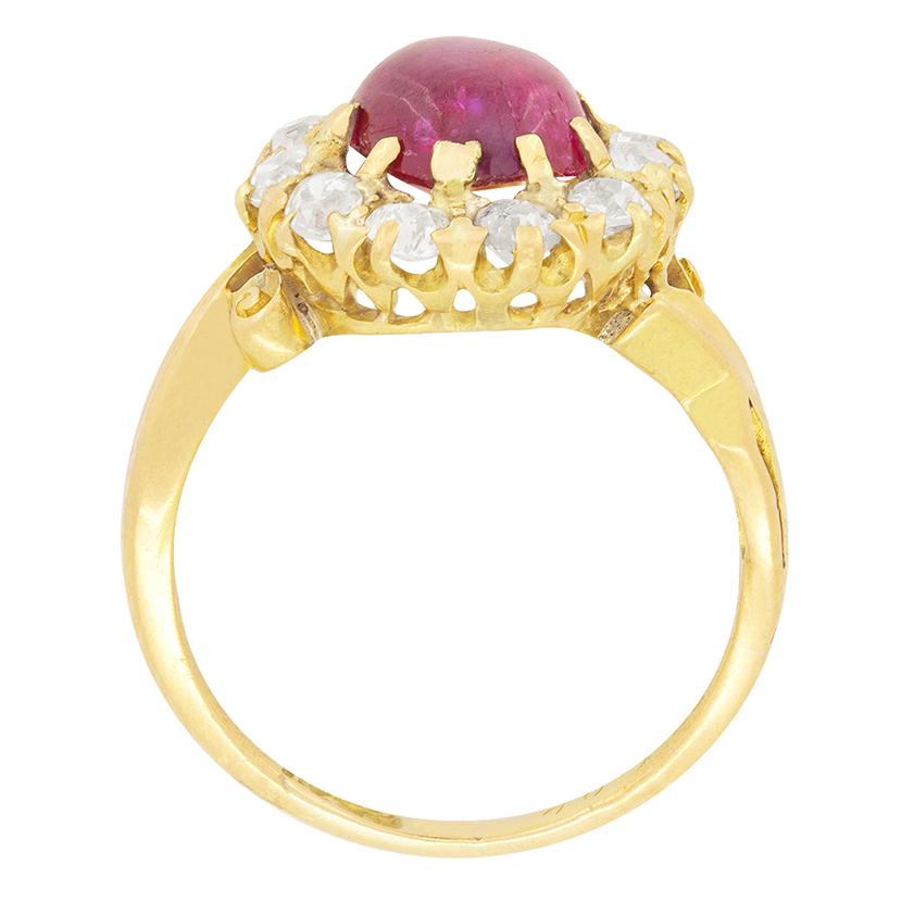 A beautiful cabochon cut ruby features at the centre of this Victorian ring. The ruby weighs 1.40 carat and is surrounded by a halo of old cut diamonds. They weigh a total of 0.55 carats and have been estimated I in colour and SI in clarity. The