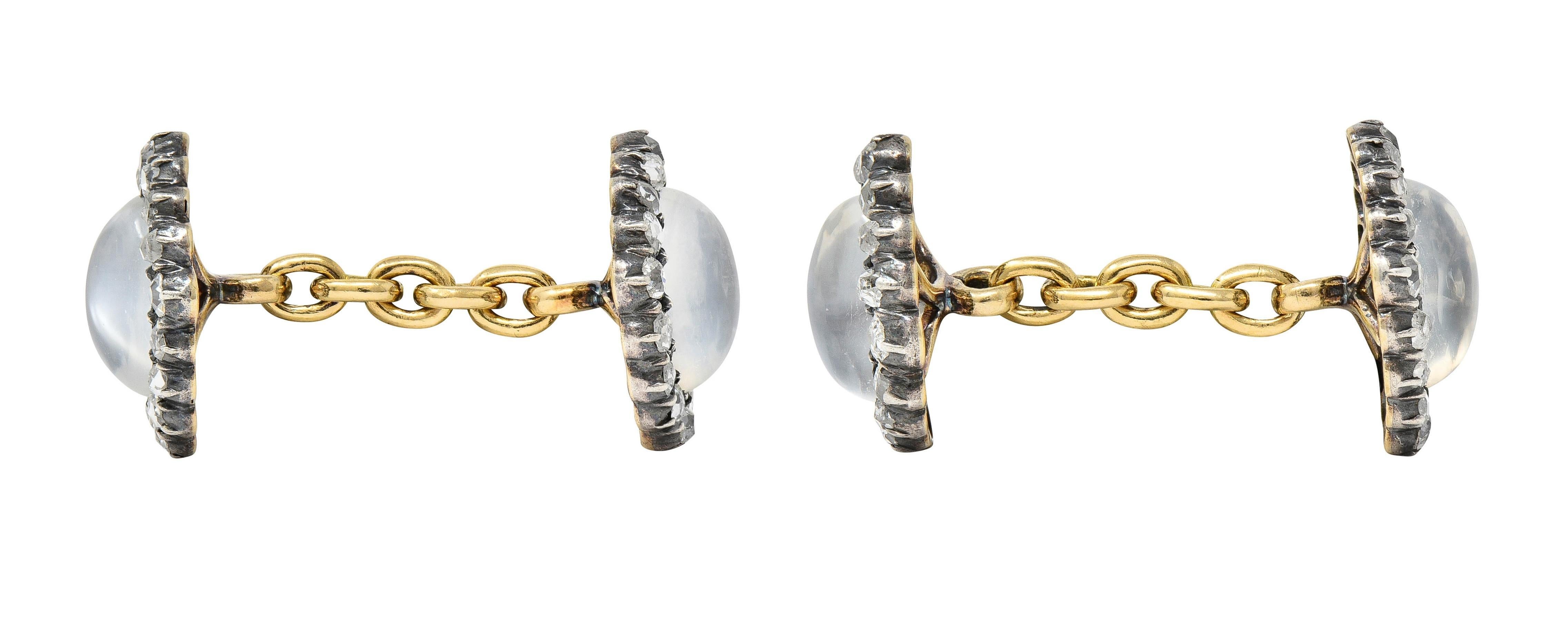 Designed as link-style cufflinks terminating with silver-topped navette-shaped forms 
Centering oval-shaped moonstone cabochons measuring 6.5 x 8.5 mm 
Translucent colorless body with white adularescence - bead set
With a halo surround of rose and