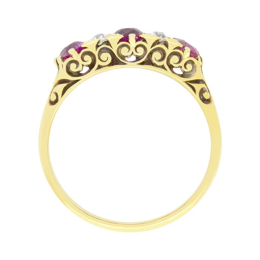 Dating back to the 1880, this classic carved shank ring features three old oval pink sapphires and two pairs of old cut diamonds set in an alternating sequence. The central pink sapphire weighs 0.65 carat with the stones at either end weighing 0.40