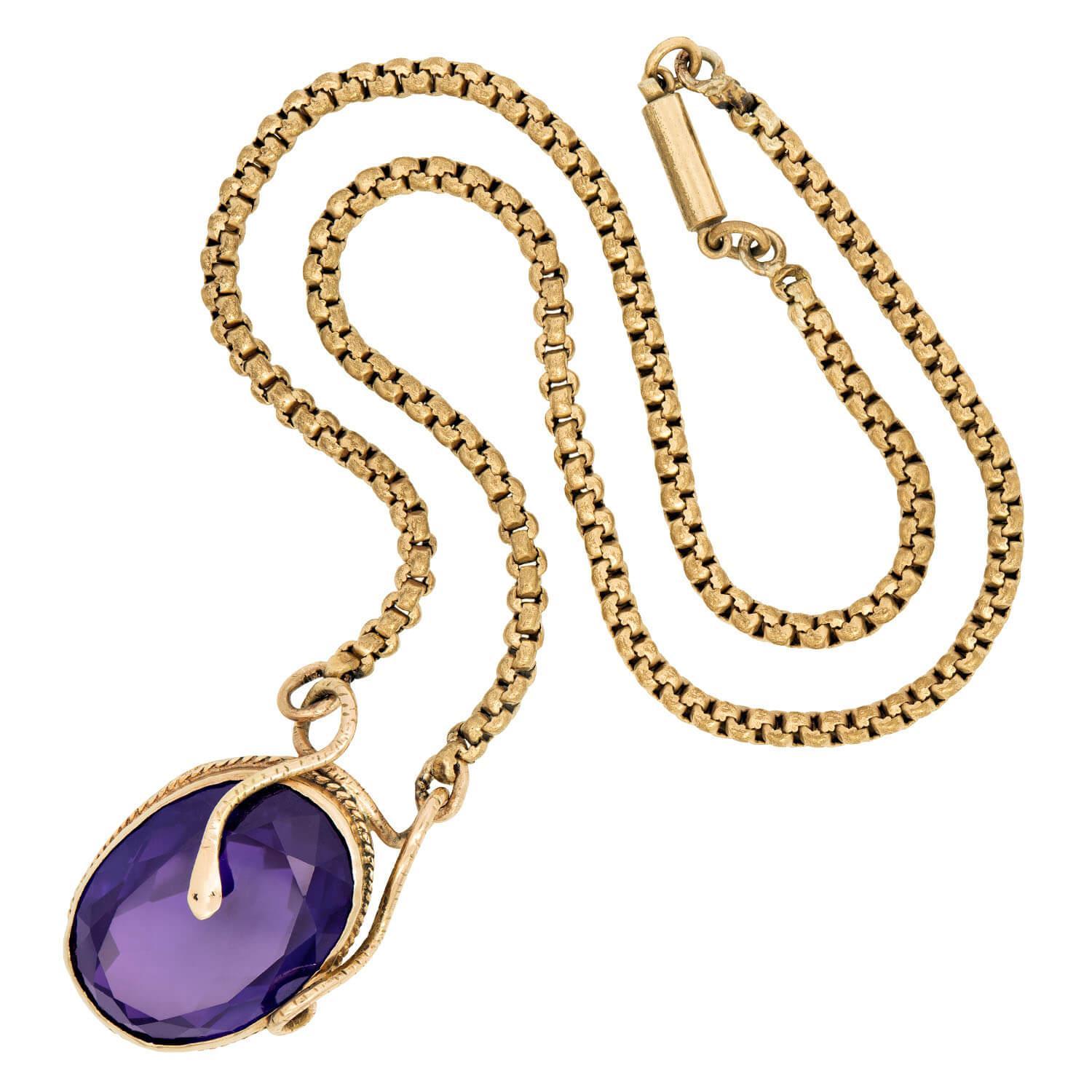 A stunning amethyst pendant from the Victorian (ca1880s) era! Crafted in 14k yellow gold, this piece features a large central oval cut amethyst stone. The amethyst rests within a bezel setting, which is surrounded by a delicate, braided border. The