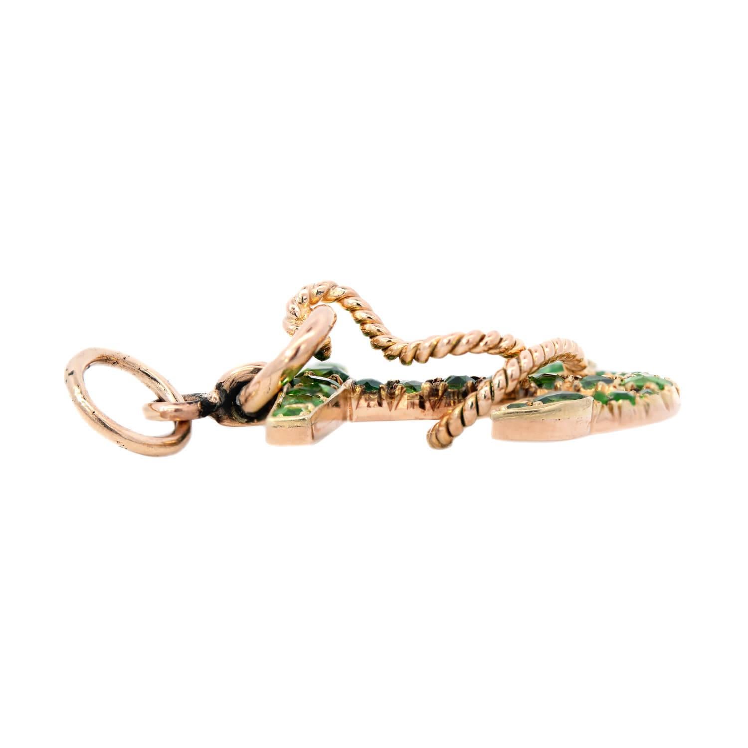 An incredible diamond anchor bar charm from the Victorian (ca1880) era! This beautiful brooch is crafted in 14kt gold, and has a stylish nautical design. Hanging from gold jump ring is a stunning gemstone anchor wrapped in a gold textured 