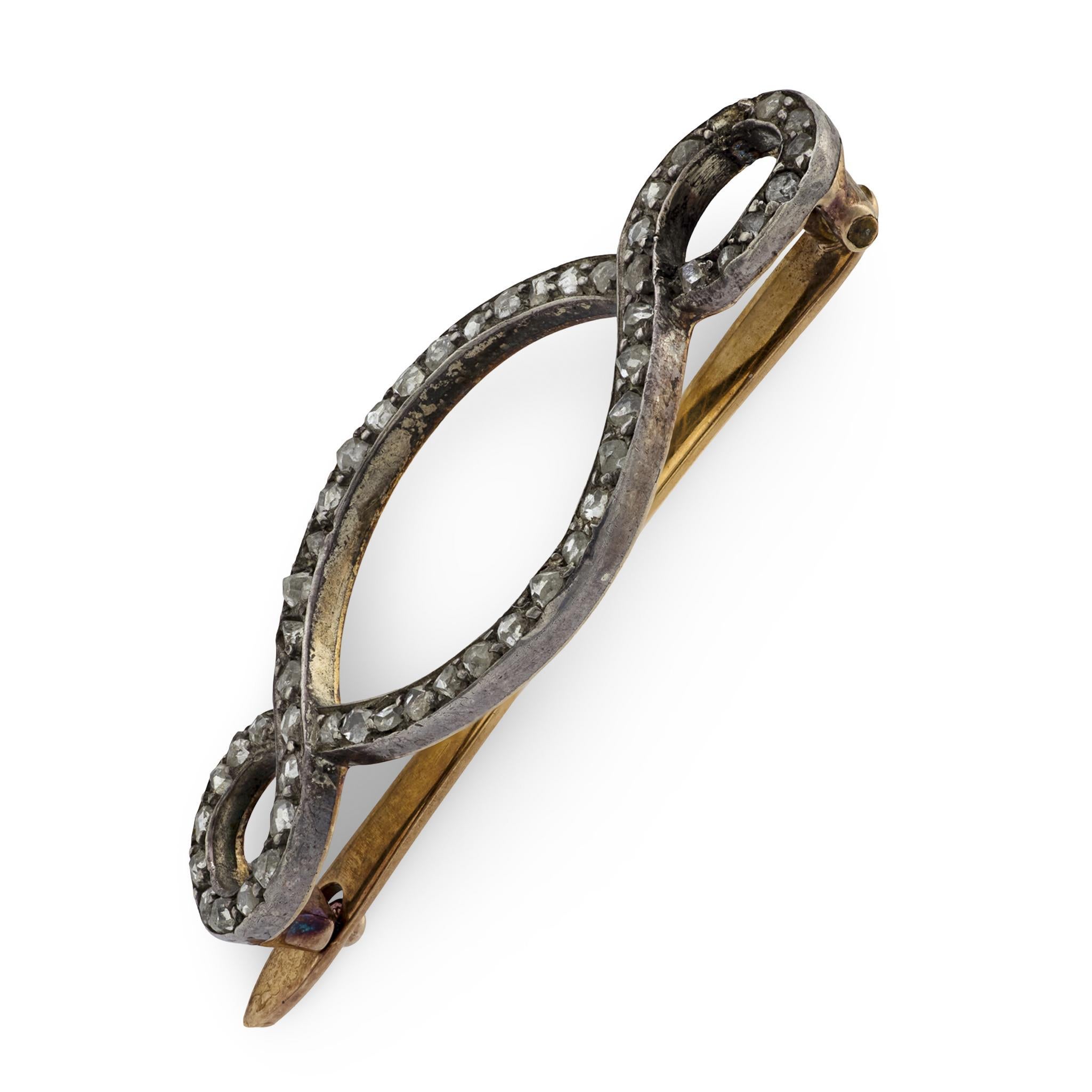 A beautiful diamond barette from the Victorian (ca1880s) era! Crafted in 14k yellow gold, the front surface of this piece features a swirling-motif. The surface of the curling-motif is encrusted with bead-set rose cut diamonds, which are