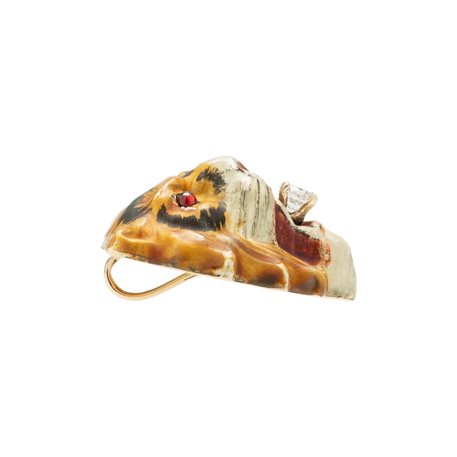 A magnificent enameled pendant from the Victorian (ca1880) era! Crafted in rosy 14k gold, the piece represents the 3-dimensional repousse face of a fierce, snarling tiger. Luscious hand-painted enamel accents cover the surface, creating an