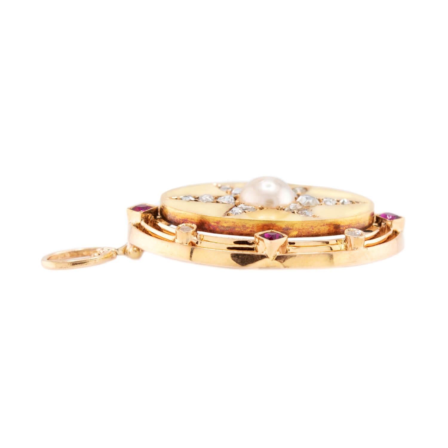 A gorgeous pendant from the Victorian (ca1880s) era! Crafted in vibrant 14k yellow and rose gold, this piece features a beautiful starburst design. The center of the pendant features a lustrous white pearl, which displays an incredible milky-white