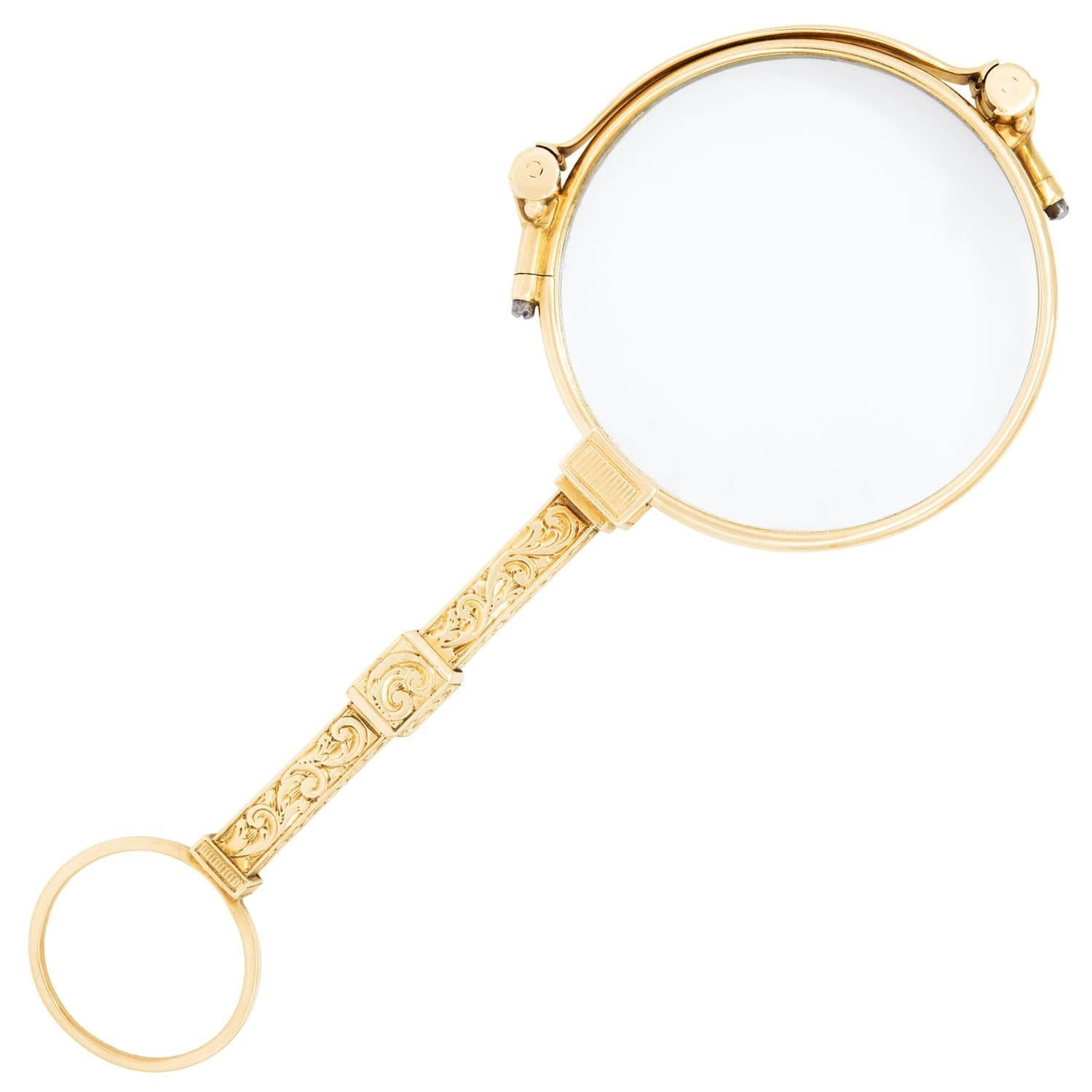A wonderful pair of folding eye glasses from the Victorian (ca1880s) era! Crafted in 14k yellow gold, the unusual piece depicts a pair of folding reading glasses encased in a breathtaking solid gold encasement. The encasement features intricate