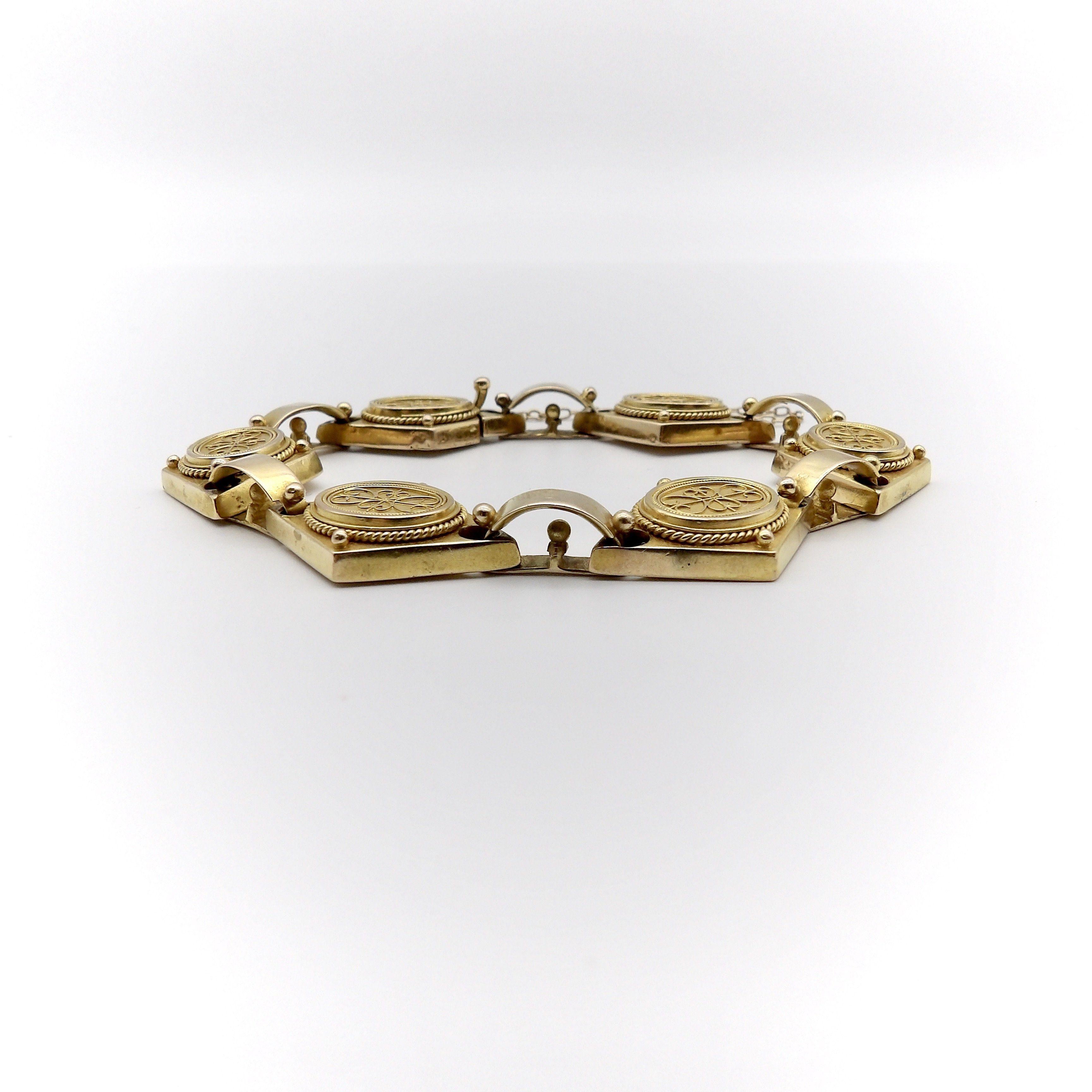 A beautiful 14k yellow gold bracelet from the Etruscan Revival period, circa 1880. The bracelet is exquisitely hand-made and is a fine example of cannetille gold work, which is similar to filigree work with fine gold wires that curl around thinly