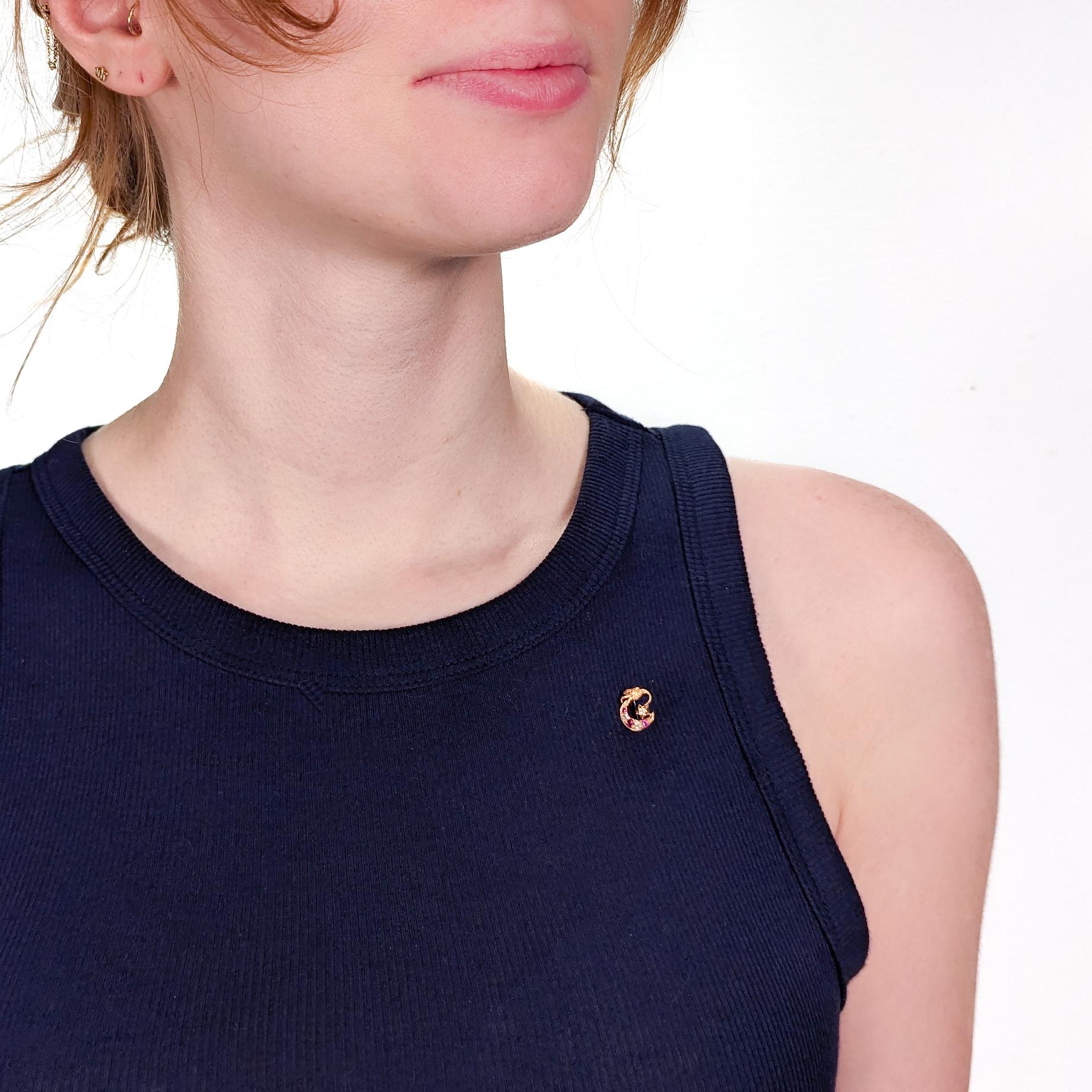 A fine antique 14k gold, red spinel, and diamond stickpin.

In 14 karat yellow gold.

Prong set with graduated diamonds and synthetic red spinels.

The stickpin's head in the form of a crescent moon and star with alternating red spinels and diamonds