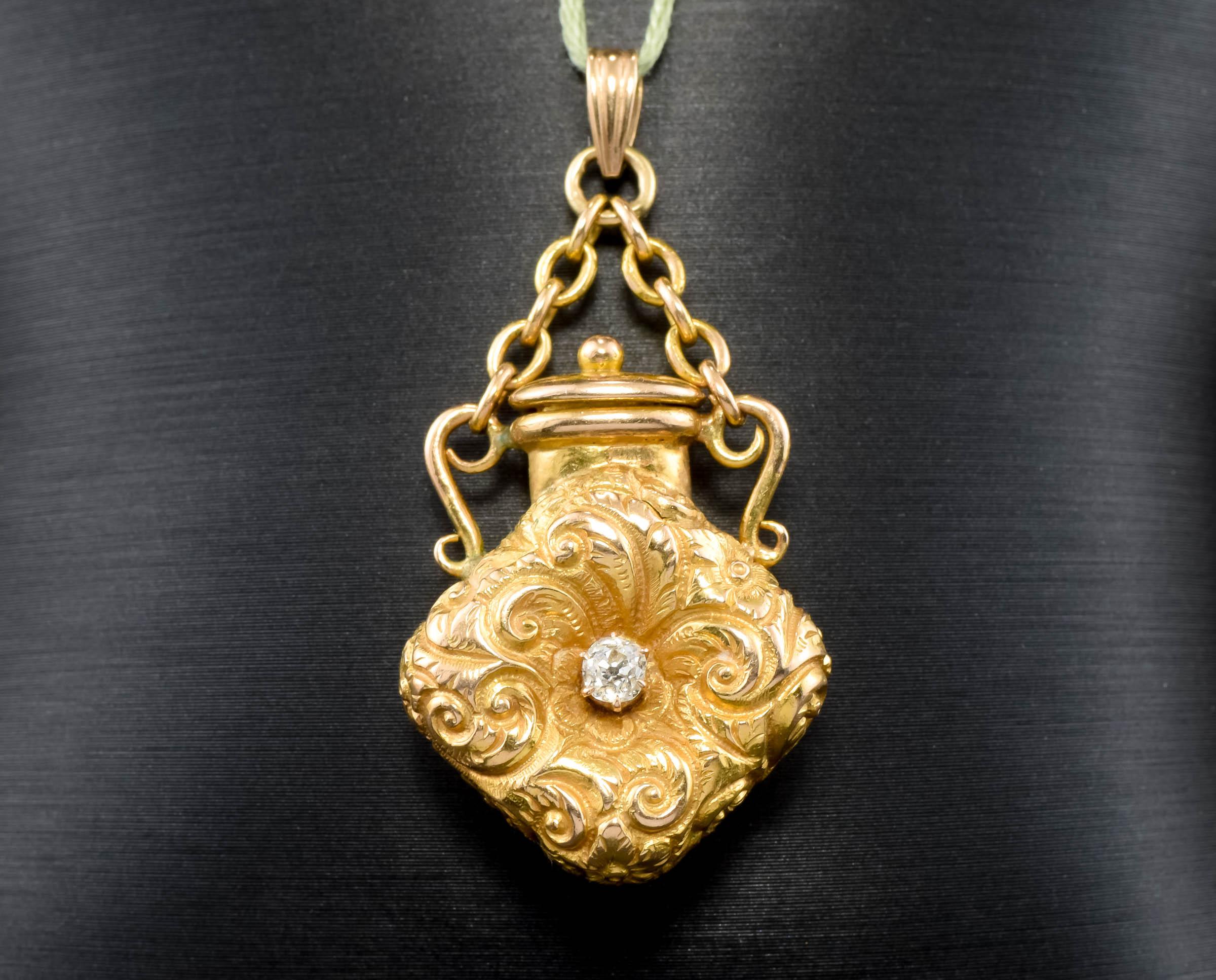 Such an elegant antique gold scent bottle dating to the Victorian period - with a fiery little old mine cut diamond, the bottle's original chain and even the little chain that attaches to the bottle's lid.

Crafted of solid 14K gold, the antique