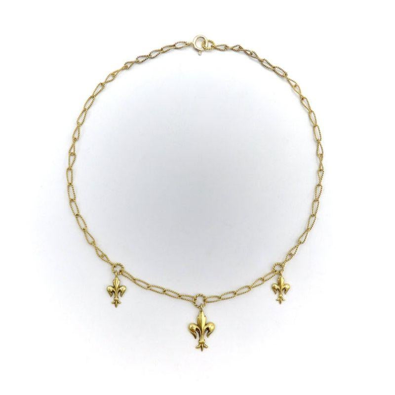 
A delicate handmade necklace from the Victorian-era, circa 1890, featuring well-sculpted fleur-de-lis. The chain is made from 14k gold wire, which was hand-twisted into elongated oval links, and then twisted again, halfway, reminiscent of a Mobius