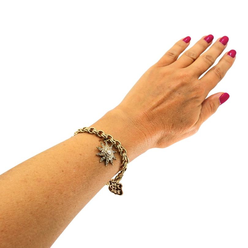 Cet exquis bracelet à breloques victorien est fabriqué en or 14 carats. Il est composé d'une chaîne à double maillon d'une longueur approximative de 7 pouces et est fixé à l'aide d'un fermoir classique en forme de boîte pour un port fiable. Quatre