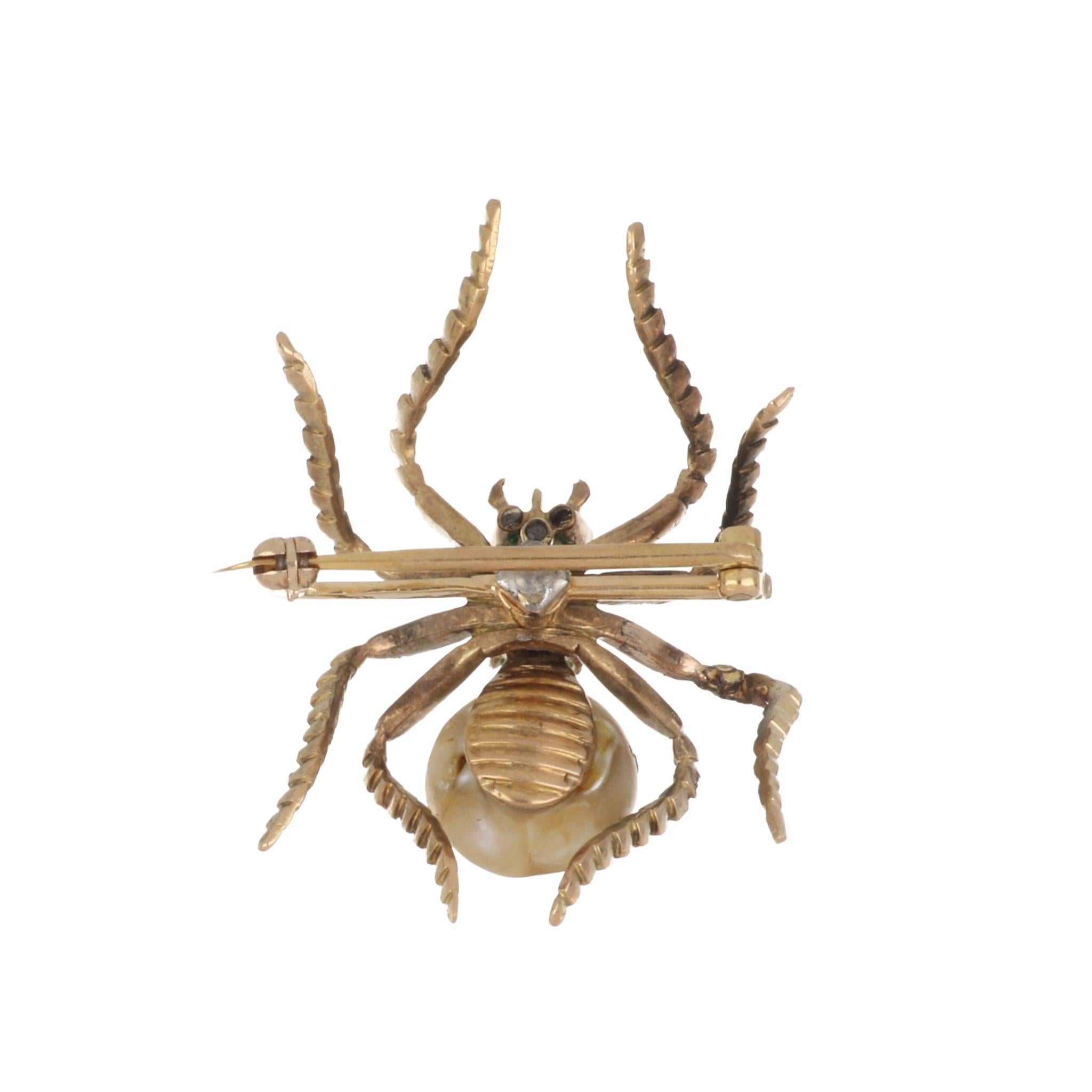 A Victorian 14k rose gold rose-cut diamond spider pin, set with a single rectangular shape emerald and natural pearl abdomen. Circa 1860. 

The spider's legs are set with 74 rose-cut diamonds totaling 0.75 total carat weight, I-J color, VS1-SI2