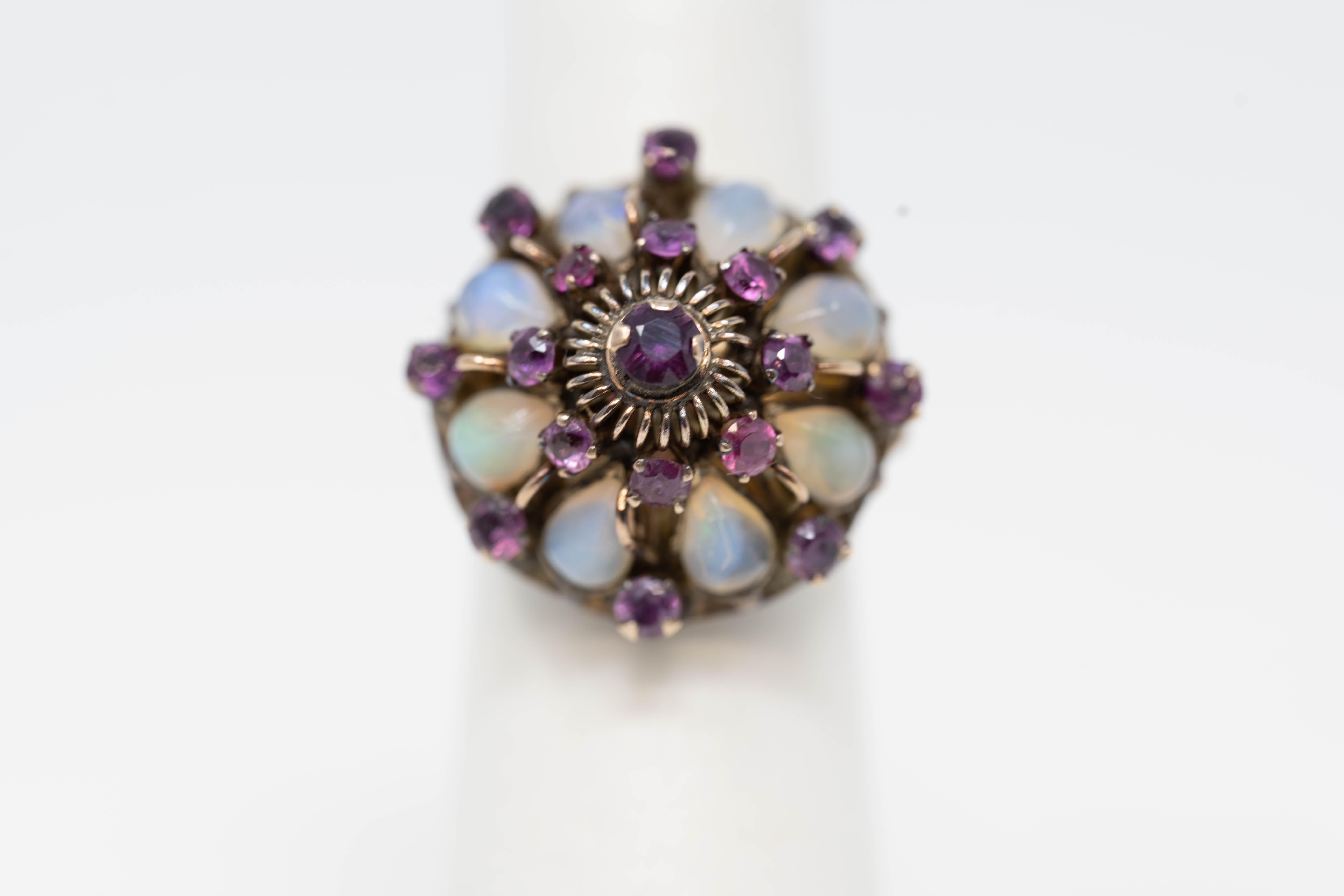 Victorian period 14k gold ladies cluster ring with 17 genuine rubies and 8 pea shaped opal stones. Stamped 14k, size 7. Weighs 6.3 grams.
