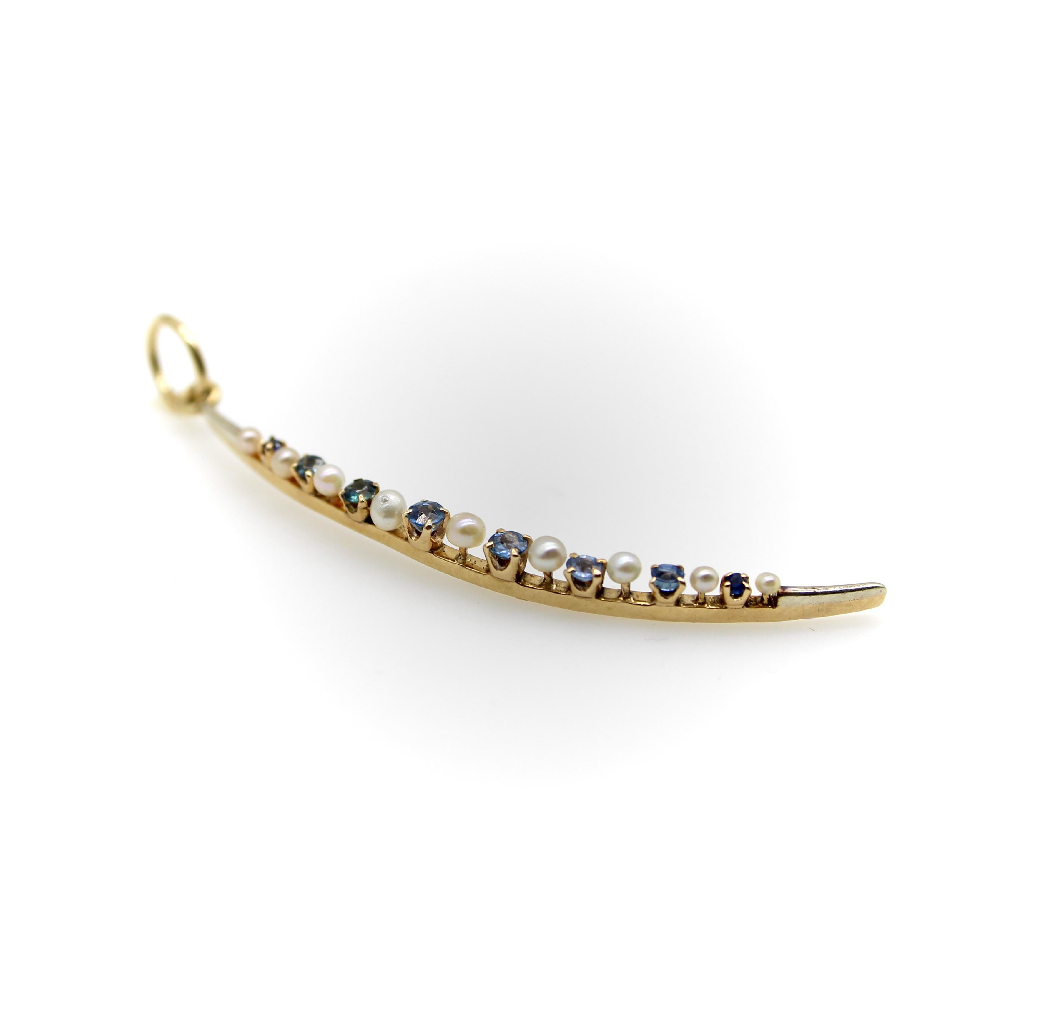 This 14k gold Victorian crescent moon pendant contains alternating sapphires and pearls that graduate in size along the pendant’s curve. Circa the 1880’s,  piece was originally a brooch, but was converted into a pendant for contemporary use. The