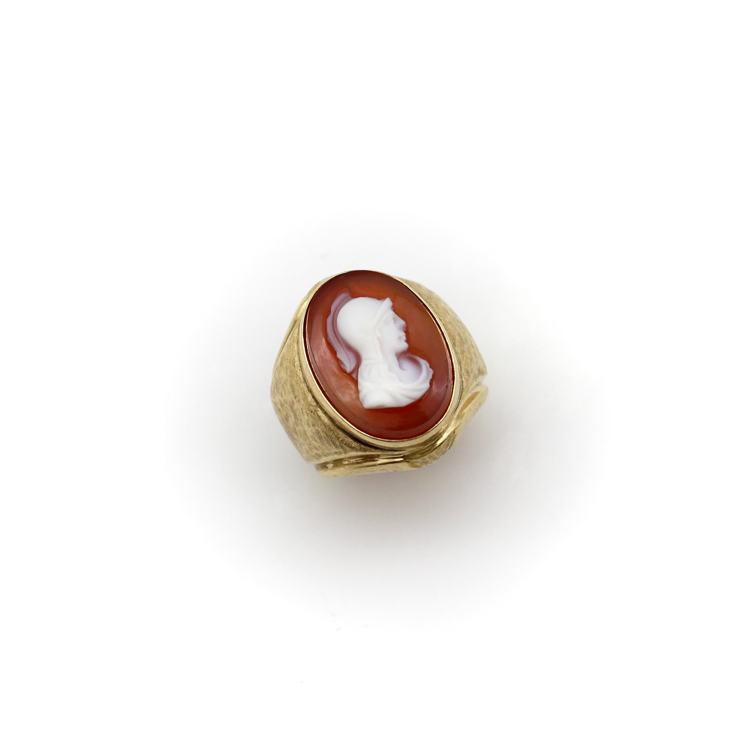 This beautiful Victorian 14k gold cameo ring, circa the turn of the century, features the profile of a helmeted warrior carved out of red sardonyx. The top layer of the stone, where the warrior is carved in incredible detail, is a creamy white,