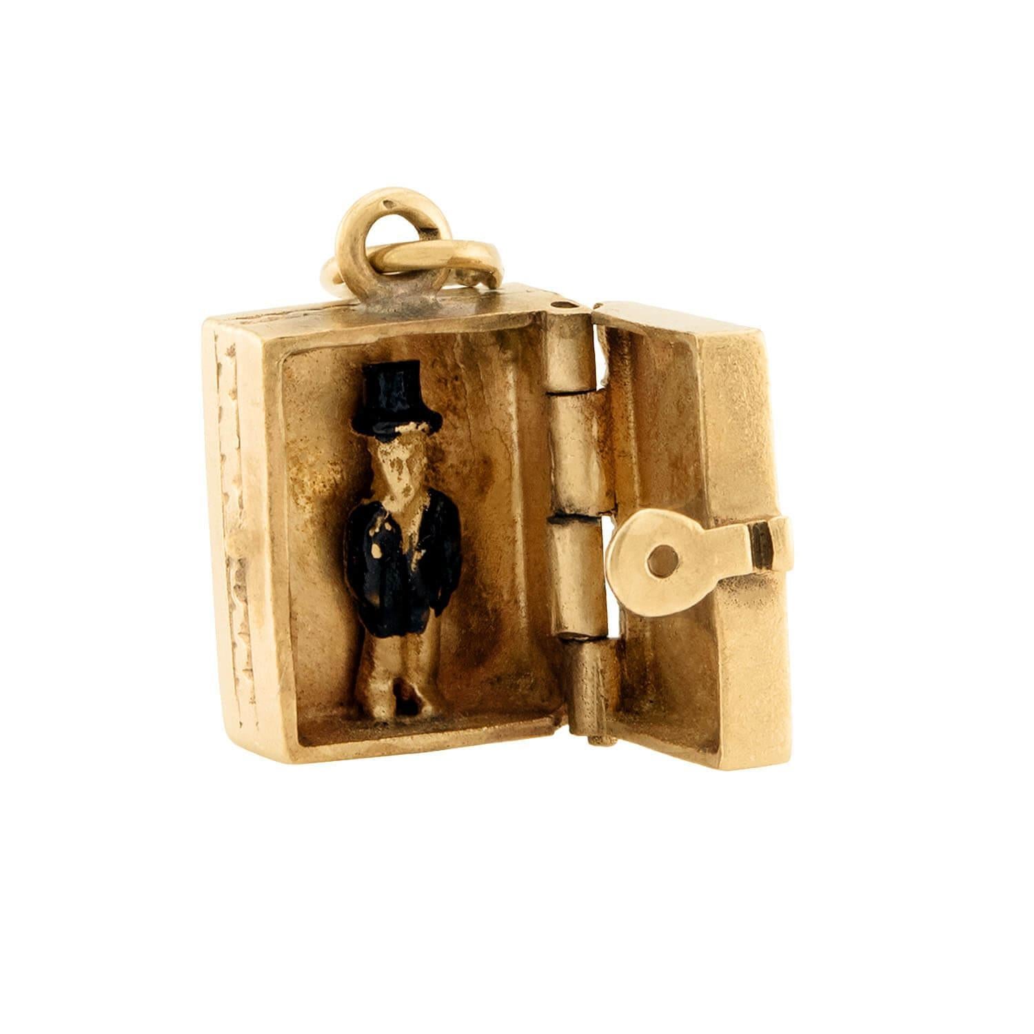 A delightful and humorous gold charm/pendant from the Victorian (ca1880s era)! This unusual and collectable piece is crafted in 14k yellow gold and features a small gold box. The exterior of the box is decorated on one side with an etching depicting