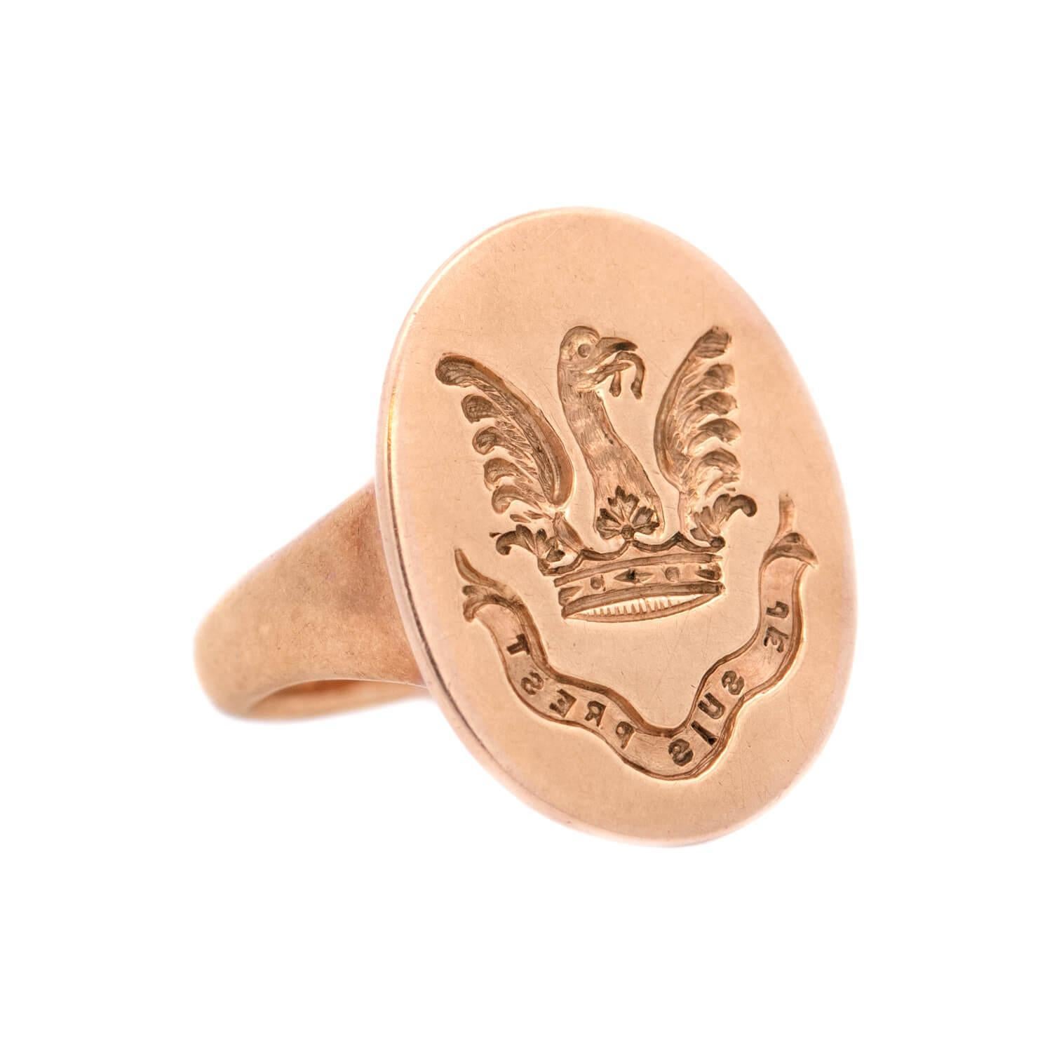 An incredible and unusual gold intaglio crest ring from the Victorian (ca1880) era! This fabulous ring is crafted in vibrant 14k yellow gold and has a large oval-shaped face with a carved family crest intaglio center. The crest features a large bird