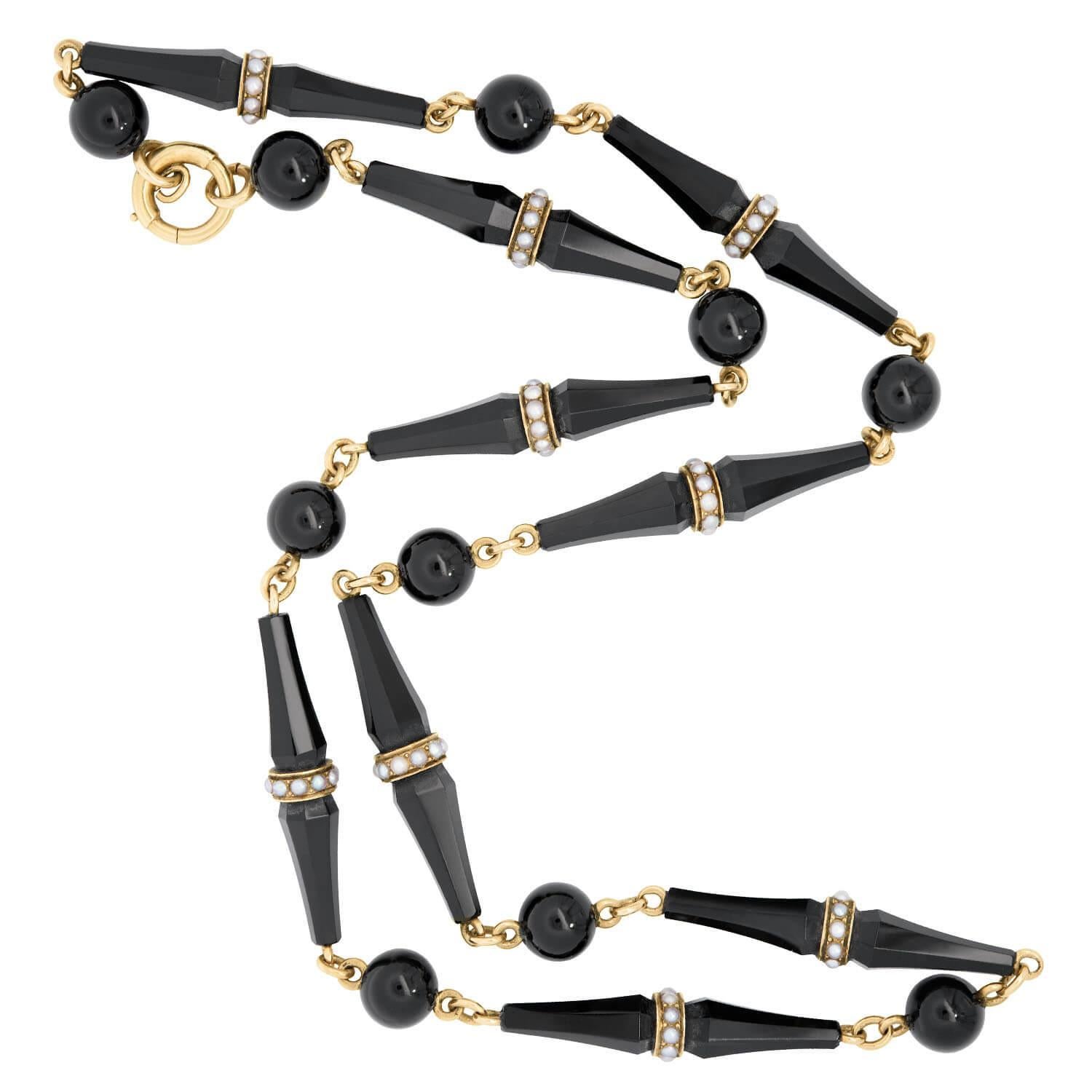 Un fantastique collier en perles d'onyx de l'époque victorienne (vers 1880) ! Réalisée en or jaune 14 carats, cette magnifique pièce est composée de 10 perles circulaires en onyx qui alternent avec 9 maillons coniques en onyx. Les maillons coniques