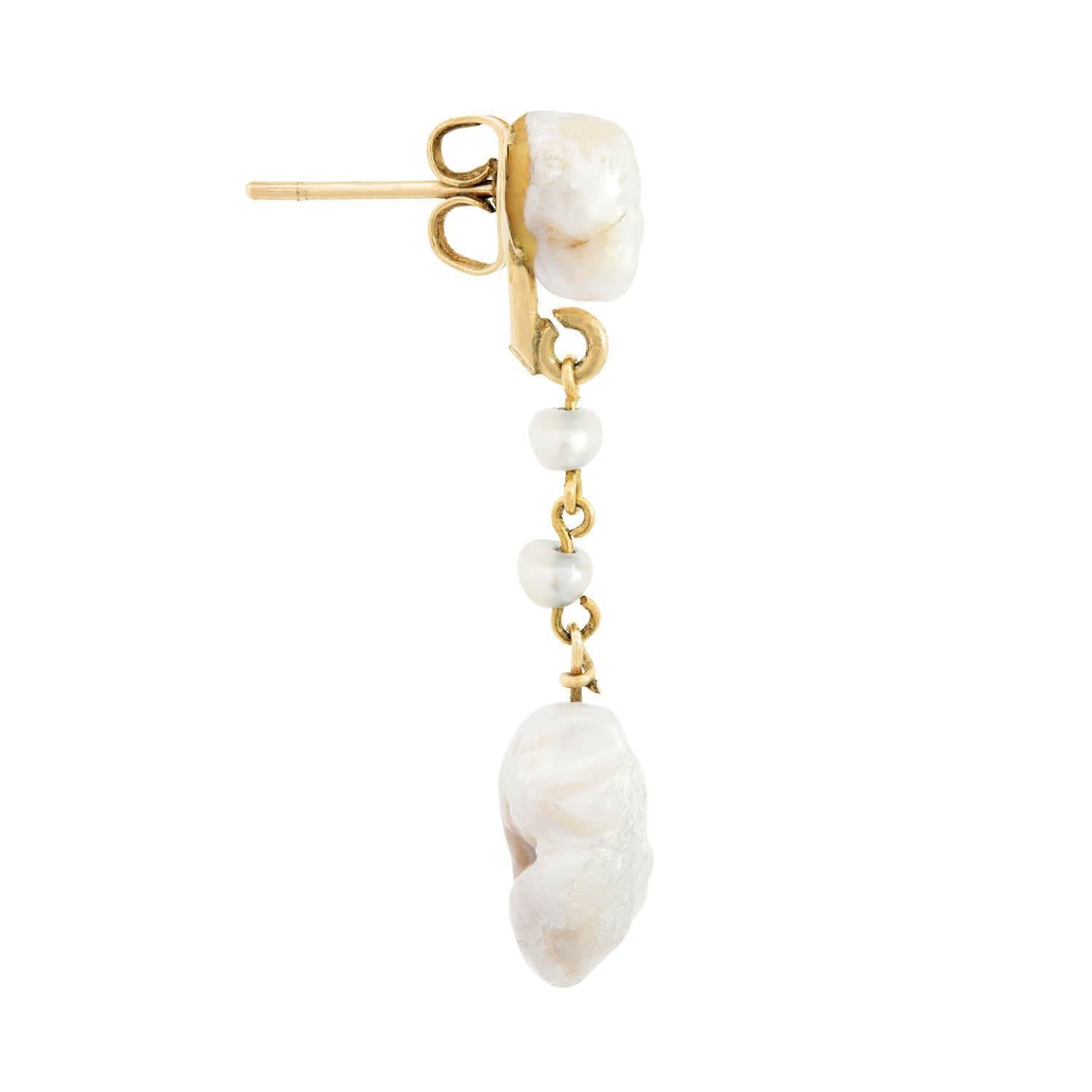 Lovely drop pearl earrings from the Victorian (ca1880s) era! Crafted in 14k yellow gold, each earring begins with an oblong Mississippi River pearl surmount. Two small pearls are connected to the surmount by gold jump rings, and dangle freely. At