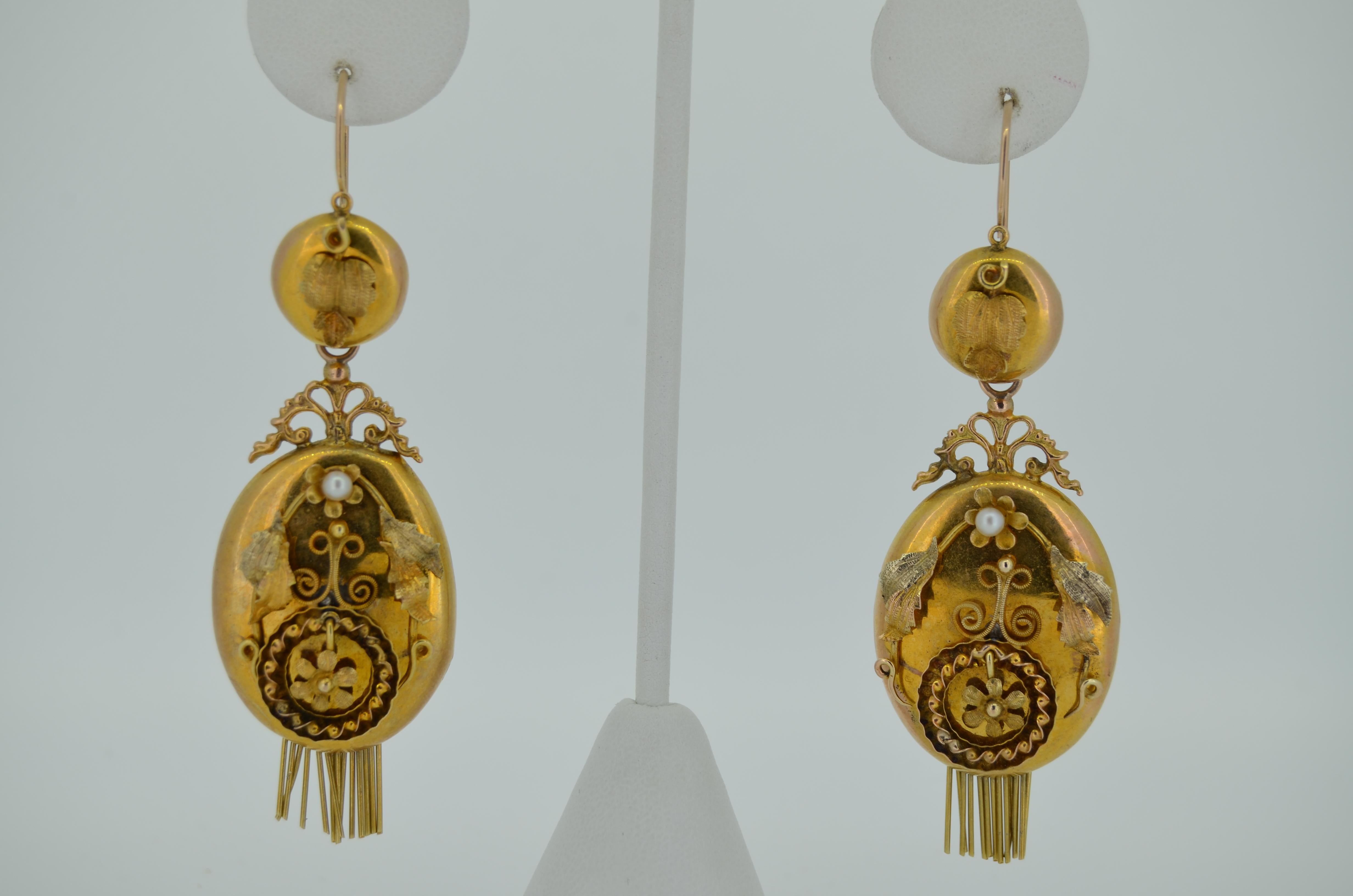 A lovely pair of Original Victorian-era earrings. These earrings date from the late 1800s. They are crafted from 14K Yellow and Rose Gold. The earrings are day and night, meaning you can adorn the ear with the button tops alone or add the massive