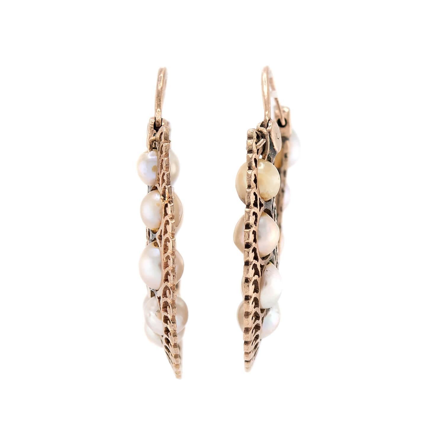 Absolutely fantastic and unusual gold and pearl hoop earrings from the Victorian (ca1880s) era! Each earring is crafted in 14k gold, and features a horseshoe-shape. The surface of each earring is decorated with 9 small pearls, which are strung on