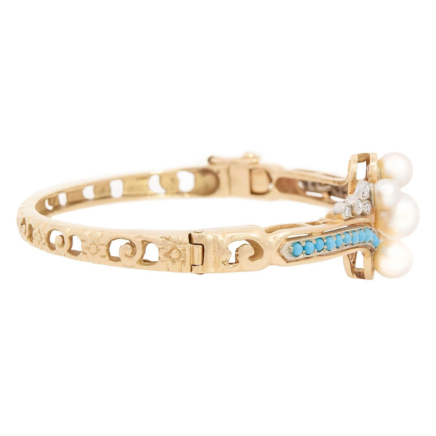 A fabulous pearl, turquoise, and diamond bangle bracelet from the Victorian (ca1880s) era! Crafted in 14k vibrant yellow gold, the front surface of the bracelet features two scrolling motifs, which meet at the bangle's center. The scrolling 