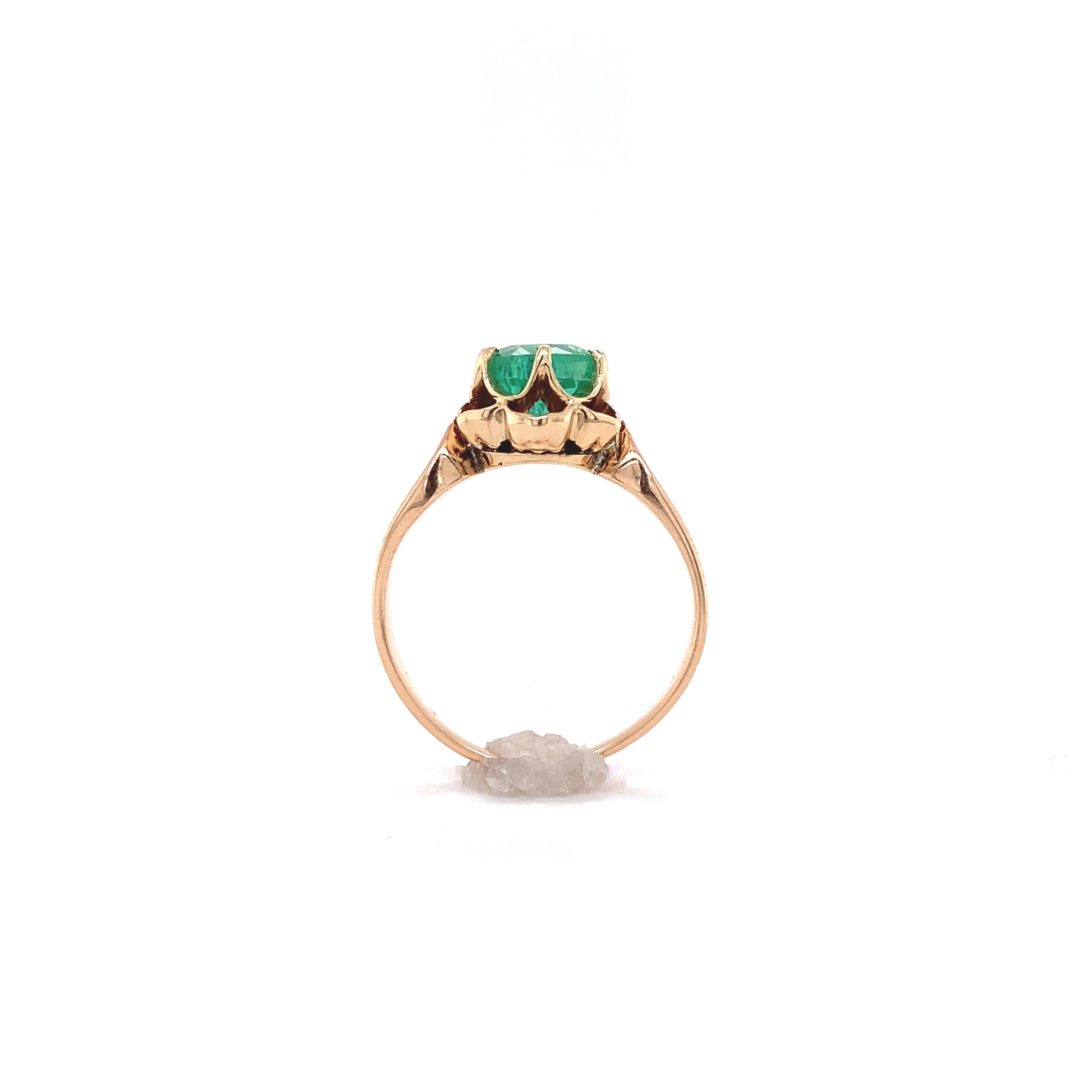 Victorian 14K yellow/rosy gold ring featuring a genuine earth mined emerald weighing .94cts. The round emerald is a lighter bright mint green color and measures about 5.9mm. The ring fits a size 4.5 finger, weighs 1.80dwt. and dates from the 1890's.